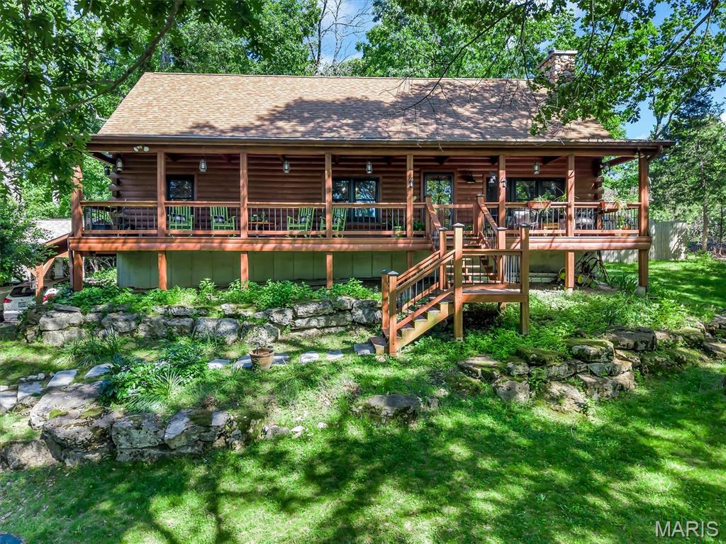 Discover a lifestyle of comfort and character at 2838 Wild Ridge Drive, a well-maintained private estate complete with large covered porch. This attractive log cabin style property offers a unique blend of rustic charm and modern amenities, promising a tranquil retreat. The kitchen is a culinary delight, featuring sophisticated granite counters, a distinctive wood wall, and a custom range hood that speaks to both form and function. In the living room, a high, vaulted wood ceiling & stone fireplace creates an expansive and inviting atmosphere, perfect for relaxation or entertaining. One of the bathrooms offers the luxury of a double vanity and a walk-in shower, complemented by a charming wood ceiling. A bedroom also benefits from the warmth and character of a wood ceiling. Beyond the interiors, a private yard awaits, complete with an inviting outdoor dining area, a spacious patio, a covered deck, and a welcoming porch, all designed for seamless indoor-outdoor living. Experience the allure of this exceptional property firsthand; schedule your private viewing today.