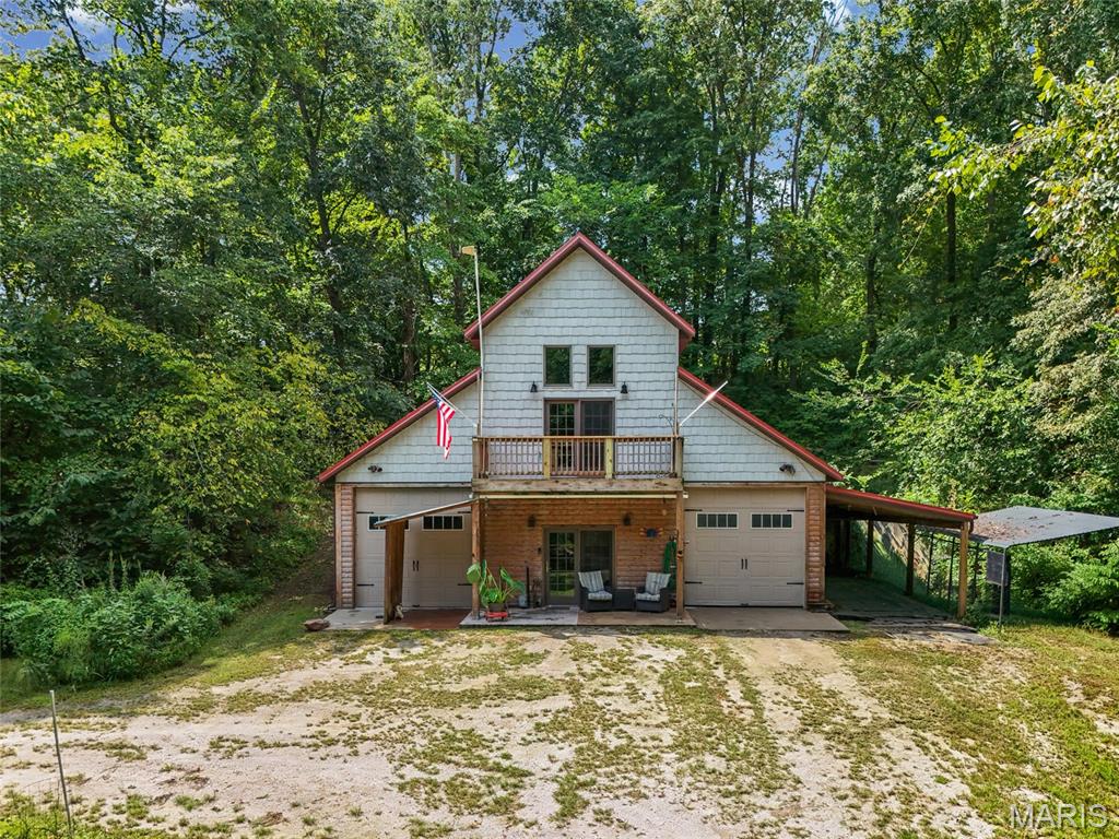 Ready to leave the traffic behind and find your way to the treeline? This A-frame cabin is tucked away on approximately 9 acres, plus an additional 8-acre lot, giving you plenty of space for peace, privacy, and room to roam.
Inside, the rustic charm really shines with walnut flooring, granite countertops, pine log walls, vaulted ceilings, and a gorgeous stone chimney. Cozy up at night by the wood-burning stove or gather around the kitchen fireplace. This home was made for relaxing and making memories.

Outside, you'll find a stone fire pit, circle drive, small creek, deep attached garage, and a carport perfect for extra storage, equipment, or even horses. There's also an updated bath, flexible bonus room, laundry/storage area, and balcony overlooking your private surroundings.

Whether you're dreaming of a hunting retreat, weekend escape, starter home, or a place to settle in and stay awhile, this property brings a whole lot of character, privacy, and possibilities. All this while still being conveniently close to town amenities. Come take a look, you just might fall in love with the A-frame life.