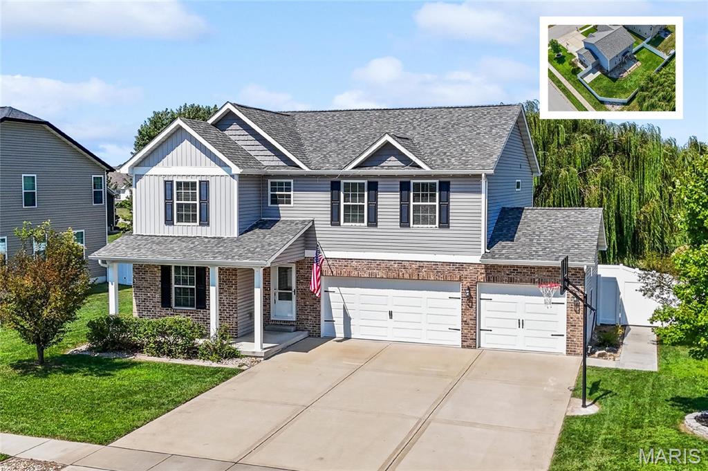 Move-in perfection in Milburn Estates! Top-rated O’Fallon schools (District 90 / O'Fallon Township High School District 204) and convenient commute to Scott Air Force Base (SAFB) make this 5-bedroom, 4-bathroom home an absolute standout. August 2026, the home has been professionally painted nearly throughout the entire home,  brand-new 9-inch+ Mohawk luxury vinyl plank (LVP) flooring on the main level installed and brand new carpet and padding installed upstairs - nearly every square foot feels brand new. A covered front porch opens to a bright main-floor flex room/office, updated foyer, coat closet, and half bath. The open-concept kitchen features solid granite countertops, a walk-in pantry, and direct flow into the dining area and spacious family room accented by a custom wood-shiplap corner fireplace. Step out to a private backyard retreat featuring a 6-foot white vinyl privacy fence and a custom built-in fire pit. Upstairs includes a large loft (ideal as a second living space), dedicated laundry room with cabinetry, full hall bath, and three large secondary bedrooms. The oversized primary suite boasts an en suite bath with tile floors, an adult-height double vanity, a jetted soaking tub, a separate glass-door shower with built-in bench, and an expansive walk-in closet. The finished basement provides a third family room, flexible gaming space, private 5th bedroom, full guest bath, and deep unfinished storage. Complete with an oversized 3-car garage, flat driveway with basketball hoop, and convenient access to Interstate 64 (I-64), Downtown O’Fallon, local shopping, and dining.