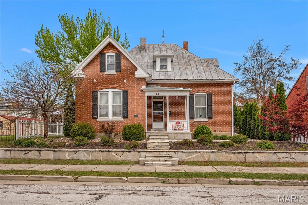 Magnificent historic guesthouse in the heart of Hermann offering an exceptional prime walkable location. This striking 5-bedroom brick Victorian is full of character and curb appeal, featuring classic architectural details and a welcoming covered front porch perfect for relaxing and taking in the charm of downtown living. Inside, the home offers spacious accommodations ideal for guests, making it a strong income-producing property or an excellent addition to an existing portfolio. Whether you choose to operate it as a full-time rental or reserve it for personal stays, the flexibility and potential are unmatched. Positioned in Hermann’s vibrant walking and shopping district, guests can easily explore nearby restaurants, wineries, and attractions, all just steps away. The convenient proximity to the Amtrak train stop adds even more appeal for visitors. A detached garage in the backyard provides added functionality, while the outdoor space offers room to unwind and enjoy the peaceful setting. With its historic charm, ideal location, and income potential, this Victorian guesthouse is a rare find and a perfect complement to the neighboring guesthouse and dining properties.