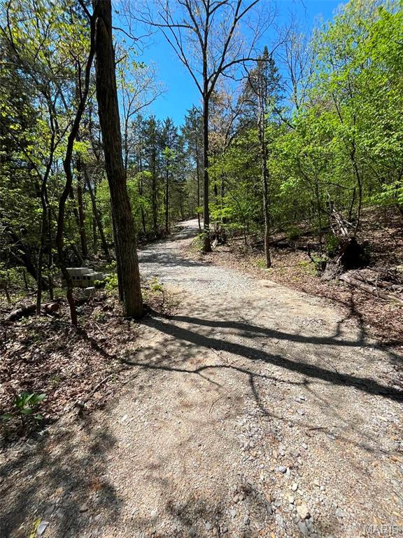 Discover the perfect blend of privacy, recreation, and future potential with this beautiful 15-acre land in Missouri, located in the desirable Grandview School District. Featuring mixed terrain, small wet-weather creek, gravel driveway, and partial clearing for approximately a 1-acre homesite, this property is ideal for building your dream home, weekend retreat, or private getaway. Electric is nearby for added convenience, and with river access just 1 mile away, outdoor opportunities are endless. No HOA restrictions give you the freedom to create your vision. A recent survey was completed in April 2024, making this property ready for your plans. Whether you're looking for a peaceful homesite or recreational escape, this land offers endless possibilities.