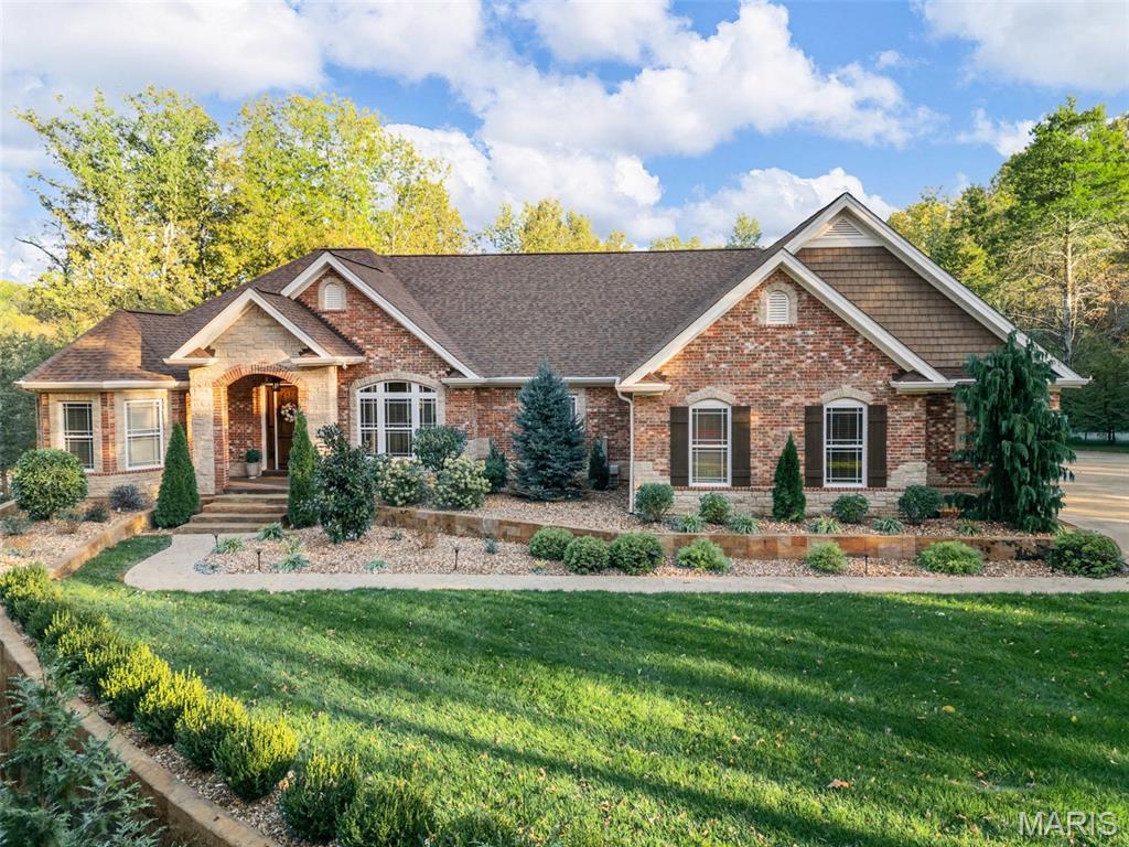 Welcome to this stunning custom ranch offering over 4,500 square feet of beautifully finished living space, set on 3 private, picturesque acres in the highly sought-after Crown Pointe subdivision. Enjoy the tranquility of a wooded setting with the convenience of being 10 minutes from Highway 40.  A tree-lined driveway sets the tone, leading to exceptional curb appeal highlighted by custom stonework, a stamped concrete walkway, lush landscaping, a covered patio, and a side-entry oversized 3-car garage.  Inside, you’ll find a thoughtfully designed open floor plan filled with natural light and elevated finishes throughout. The chef’s kitchen is a true centerpiece, featuring a copper farmhouse sink, 6-burner gas cooktop, brick backsplash, and handcrafted Amish cabinetry—perfect for everyday living and effortless entertaining.  The spacious primary suite offers a private retreat with a luxurious walk-in shower, separate soaking tub, and an expansive walk-in closet. Two additional main-level bedrooms each include walk-in closets and share a well-appointed Jack and Jill bath.  The finished walkout lower level expands your living space with a large recreation area, sauna, full bath, and two additional bedrooms—ideal for guests or multi-generational living.

This one-of-a-kind property blends privacy, comfort, and exceptional craftsmanship—offering a rare opportunity to own a truly special home.