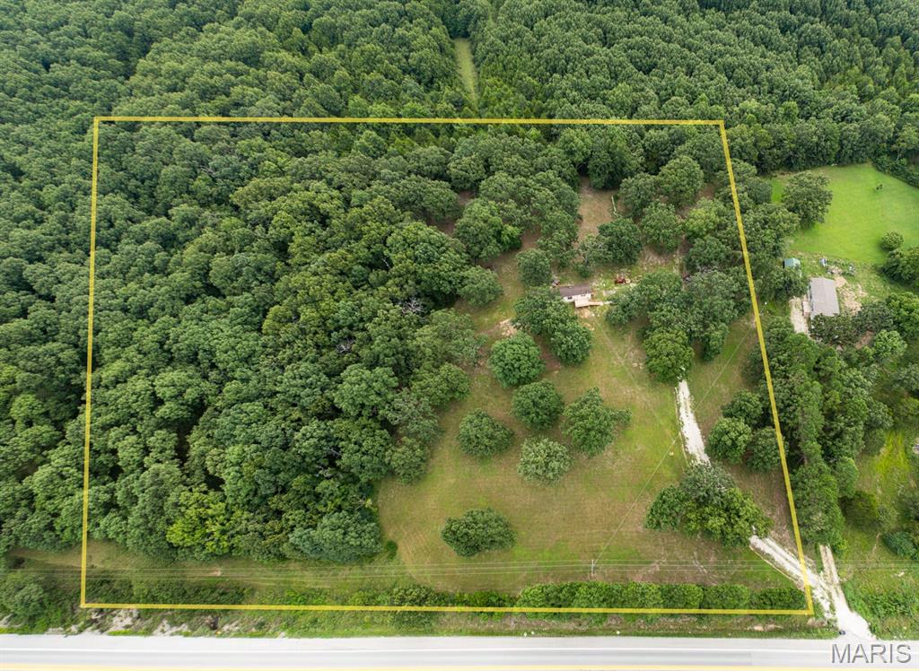 This could be your piece of heaven!  Over 8 acres of land just south of Rolla with a single wide mobile home.  2 bedrooms, 2 full baths, nice open floor plan, pantry, laundry area, big kitchen sink, pretty green & glass cabinets, vaulted ceilings and tin on the walls make for a cottage look.  Main bedroom has a private bath, but the other bedroom has direct access to the hall bath.  Well and septic are only about 2-3 years old.