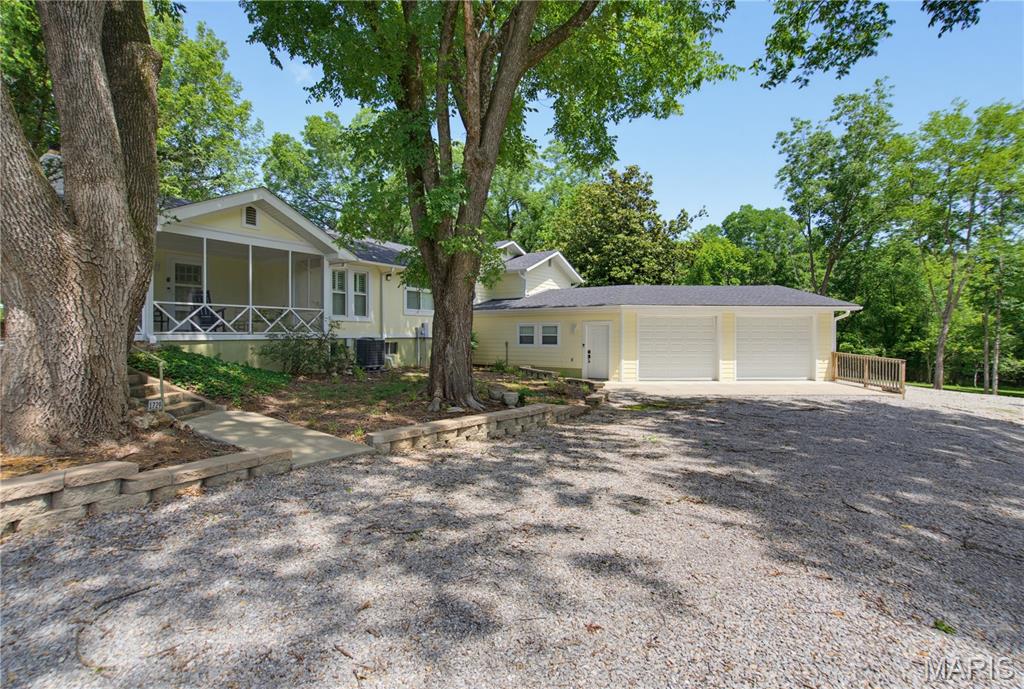 Welcome to this beautifully reimagined 2-bedroom, 2-bath cottage, thoughtfully remodeled from the studs and nestled on five impeccably maintained, park-like acres along sought after  Barron Road.  Offering the rare combination of peaceful country-style living with the convenience of being in the heart of town, you'll enjoy easy access to shopping, schools, and healthcare, while coming home to your own private retreat.
From the moment you step inside, you'll appreciate the quality craftsmanship and timeless finishes throughout.  The spacious living room is anchored by a warm, inviting fireplace, while the stunning kitchen showcases a large granite island, abundant workspace, storage and an adjoining sitting area with picturesque views of the beautifully landscaped backyard.  Gorgeous flooring and classic plantation shutters enhance the home's elegant yet comfortable atmosphere.
The light filled primary suite offers a private bath,  an entire wall of closets, and thoughtfully placed windows that bathe the room in natural light.  Upstairs, the expansive second bedroom provides exceptional flexibility and is spacious enough to accommodate multiple beds or a sofa-bed, making it perfect for family, guests, or a bunk room.
The partially finished basement adds valuable living space for a family room, game room, home office, or hobby area.
One of the home's most enchanting features is the screened-in porch, complete with a porch swing - the perfect place to enjoy your morning coffee,  unwind with an afternoon book, or simply relax while overlooking the breathtaking backyard and surrounding park-like grounds.  Additional decks on the side and rear of the home provide wonderful spaces for entertaining or enjoying the beauty of every season.
The oversized two-car garage offers generous workspace, while a separate shop with its own garage door provides ideal storage for lawn equipment, recreational vehicles, or workshop projects.
Properties of this caliber are seldom available.  Combining exceptional craftsmanship, picturesque acreage, versatile living spaces, and an unbeatable location with five acres, this remarkable property offers a lifestyle as inviting as the home itself.  Schedule your private showing today and discover everything this extraordinary property has to offer.