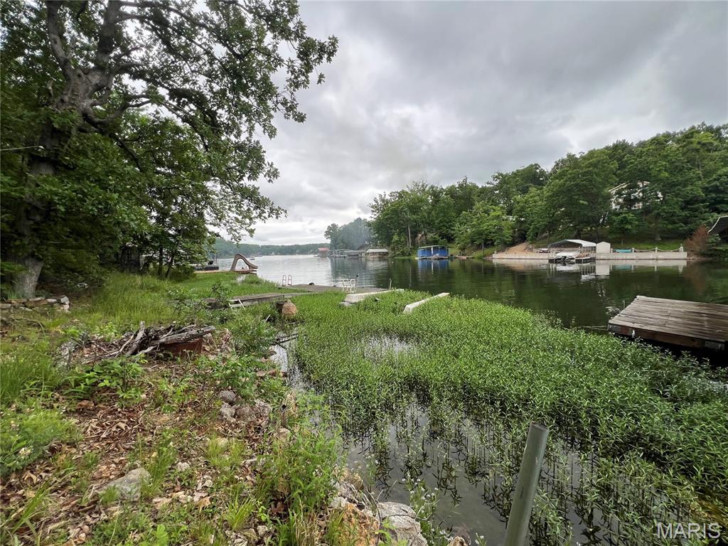 Spectacular two lakefront lots together 140 wide by 127 deep to be sold together on "Family Cove" of Goose Creek Lake Community. This property has been family owned since before the water was in the 400+ acre lake! This is the first time it is available to a non family member since that time! 6514 LaRose Lane cottage offers two bedrooms, two full bathrooms, two kitchens, two docks, deck off the main level and full walk out basement. It is a diamond property with well loved cottage that is fully functional but not fully updated and if desired fresh sparkle can be restored or an addition or an additional building may be desired opening up unlimited possibilities. The property was thoughtfully developed with the best use of the natural site in mind and terraced in multiple levels for ease of lake access including level areas, an area for minnow pond at waters edge, creating healthy fish environment hatching and reportedly a deep 20 foot water directly off the dock. This area of the lake is known to be a fun family swim spot in no wake zone and fresh water is source fed by nearby spring. The septic & well is in place on the two lot property. Big wide water access and easy ramp for boat access to be unloaded & loaded & stored directly from your property to the lake. Seller prefers AS-IS sale & Welcomes Back Up Contracts. Come enjoy the beauty of lake life!