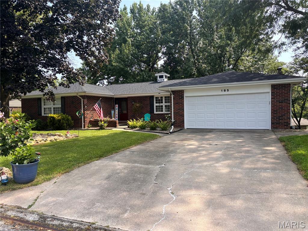 Welcome home to 185 Lake Apollo Drive! This spacious brick ranch offers the perfect blend of comfort, character, and versatility in one of Hannibal’s established neighborhoods. With approximately 3,260 square feet of finished living space, this 4-bedroom, 3-bath home provides plenty of room for everyday living, entertaining, and growing.

Step inside to a welcoming main level featuring both a formal living room and a cozy den with a fireplace, creating comfortable spaces for both entertaining guests and relaxing at home. The kitchen offers beautiful white oak cabinetry, abundant storage, and a breakfast bar that opens to the family room, keeping everyone connected while you cook and gather. Just off the den, the three-season room offers an inviting spot for morning coffee, afternoon reading, or enjoying the changing seasons. Three bedrooms are located on the main level, including a comfortable primary suite, along with a full hall bath. The finished lower level expands the possibilities with a large media/recreation room, fourth conforming bedroom, additional rooms, third full bath, laundry area, and generous storage. Whether you envision a game room, home theater, guest suite, hobby space, or entertaining area, this level offers tremendous flexibility. Outside, enjoy the patio and additional storage space/renovated workshop....perfect for keeping lawn equipment, tools, and outdoor belongings organized or fiddling on projects. The attached two-car garage provides convenient parking and abundant storage. The home has also been upgraded to fiber internet. 

Situated in a quiet Hannibal neighborhood, this well-maintained brick ranch offers space, functionality, and a layout that truly works for everyday life. If you’re looking for a home with room to spread out, entertain, and make your own, 185 Lake Apollo Drive deserves a place at the top of your list!