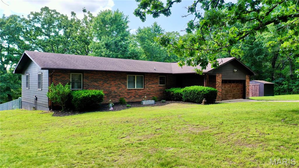 Located just minutes from town in Eastwood Estates, this beautifully updated 3-bedroom, 2-bath home sits on 1.9 acres and offers the perfect blend of comfort, style, and convenience. Extensively renovated throughout the years, this home features new laminate flooring throughout, fresh interior paint, wainscoting accents, updated lighting and fixtures, a custom entertainment wall with an electric fireplace and floating shelving, updated countertops, backsplash, and painted cabinetry, fully remodeled bathrooms, farmhouse-style sliding laundry doors, all new interior doors and hardware, and updated exterior door hardware and locks (2021). Additional improvements include a chain-link fenced backyard, accent walls in both the primary and secondary bedrooms, and fresh exterior paint on the home and storage shed (2024).
Most recently, the property received an updated A/C unit, stained deck, landscaping enhancements, a decorative wooden entryway beam, painted garage door, and newly constructed shed doors (2026). Additional features include county water, propane heat, an attached 2-car garage with attic access, and a storage shed. Move-in ready and meticulously maintained, this property offers modern updates, usable acreage, and a convenient location just minutes from town. Properties this well cared for don't come along often—schedule your showing today!