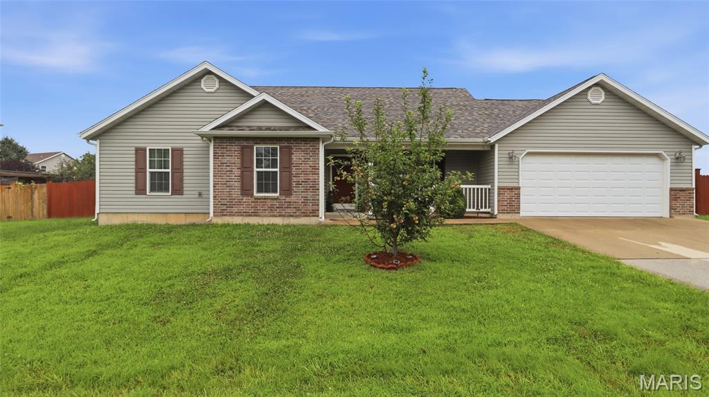 Welcome home to this beautifully maintained 3-bedroom, 2-bath home in Waynesville, where comfort, style, and functionality come together in a move-in-ready package. From the inviting covered front porch to the spacious backyard, this home is designed for both everyday living and effortless entertaining.

Step inside to an open floor plan highlighted by vaulted ceilings that create a bright, airy feel throughout the main living area. Laminate flooring flows through the living room, where a built-in electric fireplace serves as a warm and inviting focal point. The kitchen features durable tile flooring and overlooks the living and dining spaces, making it easy to stay connected while preparing meals or hosting family and friends.

The private primary suite offers a relaxing retreat with an ensuite bath featuring dual sinks, a separate jetted tub, and a walk-in shower—perfect for unwinding after a long day. Soft carpet in the bedrooms adds warmth and comfort, creating cozy spaces for everyone.

Step outside to enjoy the back deck overlooking a fully fenced yard, ideal for pets, play, gardening, or weekend barbecues. A storage shed provides extra room for tools, lawn equipment, or outdoor hobbies, adding even more convenience.

Conveniently located near Fort Leonard Wood, schools, shopping, and dining, this well-cared-for home is ready for its next owners. Don't miss your chance to make it yours—schedule your private showing today!