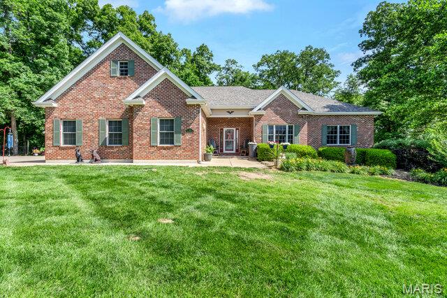 Welcome to this exceptional 4,500+ square foot custom-built ranch home perfectly situated on a park like 3-acre lot, offering an outstanding combination of luxury, comfort, and functionality. From the moment you arrive, the professional landscaping and inviting curb appeal set the tone for what awaits inside. Step through the front door to find tons of natural light, gleaming hardwood floors and soaring ceilings. The main level features large living room, formal dining room, hearth room w/wood burning fireplace & custom-built ins and separate breakfast room. Kitchen offers 42” custom cabinets w/ crown molding, quartz tops, prep island, sink in peninsula, custom stone backsplash, pantry cabinet & separate walk-in pantry. You will have a laundry room to be envied with tons of storage & custom laundry cabinets. The main-level primary suite serves as a private retreat with separate exit to the back deck, and a spa-inspired bath featuring separate vanities, a large walk-in shower w/ custom onyx surround, and a jetted soaking tub, water closet & large walk-in closet. Upstairs, you'll find a versatile bonus room that can accommodate a variety of needs with separate heating & cooling. The walk-out lower level expands the living space with an additional family room, recreation room, a safe room, and tons of storage & second ensuite with separate attached living space, full bath & large walk-in closet.  Outside, enjoy private, peaceful country views from the deck overlooking the expansive backyard. Adding tremendous value and versatility is the newer 50' x 24' outbuilding, providing ample space for equipment, hobbies, vehicles, workshop use, or additional storage. Outbuilding features concrete floors, electric, propane heat, foam insulation walls & ceilings, 10’ insulated overhead door, extra parking pad on the outside. This home also has a whole house Generac Generator, supplemental wood heat w/water furnace, an EV charger in the attached garage & all interior walls are insulated. Roof is only 1 year old. Water heater is BRAND NEW. Tranquility meets quality here in this one-of-a-kind home.