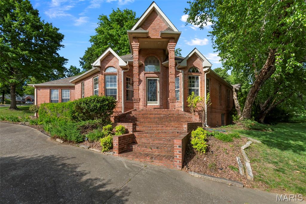 Welcome to 2204 Crown Point in Cape Girardeau - offering over 2800 finished square feet with room to grow! With over 1900 square feet on the main level, this all brick home delivers spacious, comfortable living from the moment you walk in. The main level features three bedrooms all with vaulted ceilings, including a generous primary suite complete with soaking tub, separate shower, dual granite vanity, and his-and-hers walk-in closets. The second bedroom offers its own attached full bath, while the third bedroom sits conveniently next to a full hall bath -perfect for guests to access as well. The heart of the home showcases a large open-concept living room and formal dining area with a vaulted ceiling, cozy gas fireplace, and numerous windows creating a warm and inviting space flooded with natural light. The kitchen offers granite countertops, stainless steel appliances, and an eat-in area that flows into a spacious sunroom - ideal for relaxing or entertaining year-round. You’ll also appreciate the convenience of main level laundry. The partially finished walkout basement expands your living space with two additional bedrooms, a full bath, and a large family room, ample storage and the opportunity to easily finish even more square footage to fit your needs, plus added peace of mind with a newer two year old HVAC system. Situated on a desirable corner lot in a quiet neighborhood, this home offers both privacy and space to enjoy the outdoors, with a sunroom and patio perfect for relaxing or entertaining. Combining all-brick construction with generous square footage and a flexible layout, don’t miss your chance to make this exceptional home yours!