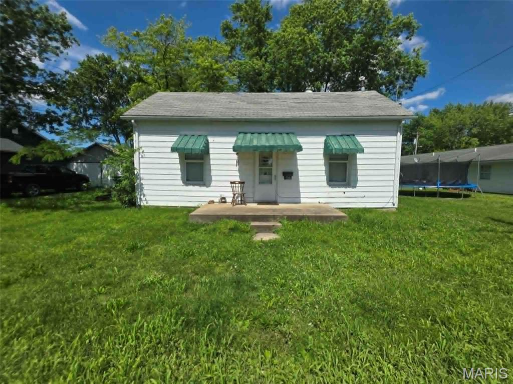This house could be a great investment property.  It is 2 bedroom, one bath, with a large shaded back yard.  It has large trees for shade, a detached two car garage, and is convenient to the elementary school.  It has an eat in kitchen, and a back porch that was converted to an enclosed laundry room. The property will be sold as is.