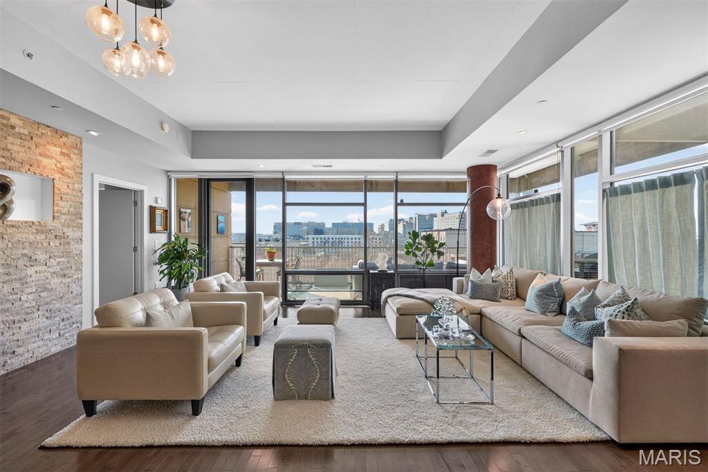 PRICE IMPROVED! A private perch above the Central West End - where sunsets become a nightly ritual. Set in a striking concrete building with direct elevator access and doorman service, 4545 Lindell #20 offers full-service living where you can arrive home to ease, calm, and quiet luxury. A wall of windows pulls in golden light and skyline views, and the generous wraparound balcony sets the scene for slow mornings, late dinners, and city-light evenings - elevated above it all, yet right in the heart of it. The upgraded kitchen pairs beauty with function, featuring GE Café appliances, quartz countertops with a full-height quartz backsplash, and a custom tiled island made for meals and moments.The spacious, open layout includes three bedrooms and 2.5 baths. The serene primary suite features a walk-in closet, dual sinks, and an oversized jetted tub, for long moments of quiet luxury. Two assigned garage spaces, private storage, and amenities including a fitness room, an entertainment room with a prep kitchen and patio, and a guest suite complete this rare Central West End lifestyle—refined, effortless, and beautifully lived.