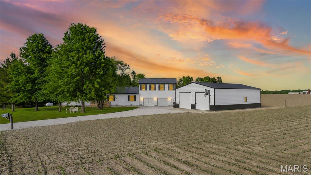 Situated on 1.62 scenic acres in Greene County, this spacious property offers over 4,000 sq. ft. of living space with room for everyone and everything. Featuring 4 bedrooms, 5 bathrooms, multiple living areas, and a walkout lower level with bonus space, this home was built for comfortable living and entertaining alike. The brand new addition of a 30x50 shed adds incredible value and versatility, offering exceptional space for equipment, vehicles, hobbies, storage, or the ultimate workshop setup. Whether you need room for business, recreation, or outdoor toys, this impressive addition provides endless possibilities. Inside, you’ll find an inviting kitchen and dining area that opens into the family room, a spacious primary suite with walk-in closet and private bath, plus an oversized upper-level bedroom with its own bath and walk-in closet that could easily serve as guest quarters or a private suite. Outside, enjoy peaceful country views from the large back deck along with the added charm of a chicken coop and the durability of a metal roof. A rare opportunity to enjoy the space and freedom of country living with the upgrades and functionality buyers are looking for.