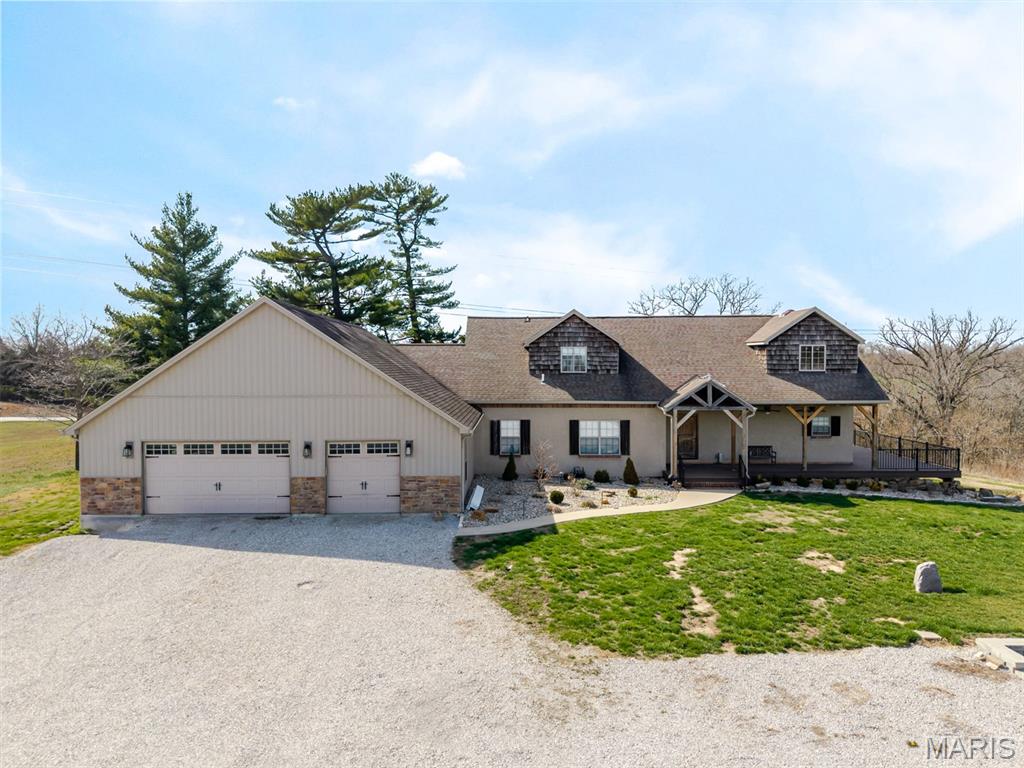 Country living with all the extras! Spacious 4 bed 4 bath home located on just over 11 acres. New roof March 2026! Open floor plan with knotty pine cathedral ceilings. Amazing functional kitchen with double ovens, gas stove top with griddle, large walk in pantry and breakfast bar. Main floor primary suite with large walk in closet and private deck. Walk in rain shower highlights the primary bath with separate water closet and dual sinks. Stunning reclaimed 1800s barnwood from a barn that previously sat on the property is featured as the fireplace mantel and wood beam columns surrounding the staircase. Barnwood was also upcycled as part of the back covered patio and front porch! Upper level offers flexible loft space and 2 bedrooms connected with an impressive layout Jack & Jill bathroom. Enormous office space with access from the attached garage and laundry room provides ample room for any activities. Lower level partially finished with bonus room w/ closet, & 3-4bath and family/rec rooms. Beautiful outdoor space with a mini orchard, wrap around deck, outdoor grill, and limestone fireplace/back patio. The best feature of this expansive property is the 600+/-sqft pool house recreational suite (added in 2024) with fiber glass heated salt water pool, includes a living space w/ glass retractable door to pool area, kitchen, spare room with laundry hook up, and full bathroom with pool patio access attached to the 40x40 pole barn for all the extra toys and equipment. Also at far back side of the property is a covered equipment structure. This peaceful rural retreat is ready to be yours!