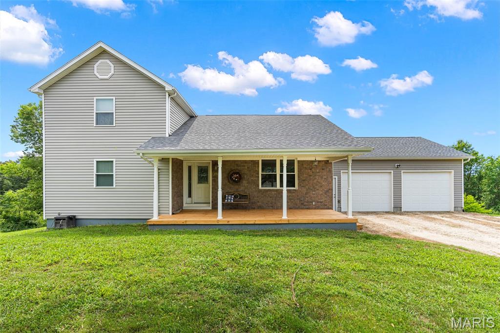 Nestled on 2.1 picturesque acres, this charming 1.5-story home offers the perfect blend of peaceful country living and everyday comfort. Complete with a shed with an attached lean-to, and a two-car garage 28 x 24, the property provides plenty of space for hobbies, storage or outdoor projects. Inside, you'll find a spacious living room with vaulted ceilings accented by a beautiful exposed beam. The living room flows seamlessly into the dining area, creating a warm and inviting space for gathering. The charming kitchen offers character and functionality with custom alder wood cabinets and backsplash, while a comfortable main level bedroom and full bath adds convenience. Upstairs feature two generously sized bedrooms, a full bath and cozy loft area overlooking the dining and living room, giving an open, airy feel. The walk-out basement includes a possible family/rec space with bar, concrete floors, laundry area and ample storage. Step outside and take your pick. Enjoy your morning coffee on the covered front porch, or unwind on the roomy 22 x 13 upper back deck or lower patio while taking in the gorgeous views. The expansive yard offers endless opportunities for recreation, gardening, and enjoying nature. On the property are mature blackberry bushes, pear and persimmon trees, a strawberry patch, and an established asparagus bed. Great location! Must See, call to set up your appointment today.