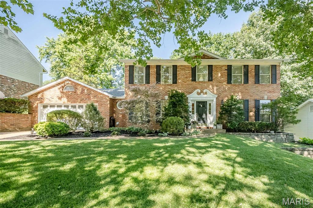Stately full-brick front updated two-story home tucked away in a sought-after Ballwin neighborhood, known for its established streets, mature trees, and easy access to parks, convenient to shopping, and top-rated schools. This home offers the perfect blend of comfort, style, and functional living space for today’s lifestyle. A welcoming entry foyer opens to a versatile living room or private home office, along with an elegant formal dining room—ideal for hosting holidays and gatherings. The beautifully updated kitchen is truly an entertainer’s dream, featuring an abundance of custom espresso cherry cabinetry, quartz countertops, and an oversized center island with seating. High-end stainless appliances include a 6-burner gas cooktop, Ultima Cook microwave with crisper, and a warming drawer. A tucked-away coffee bar adds charm and convenience. The kitchen flows seamlessly into the bright breakfast room with French doors leading to a spacious updated deck, and opens to the grand family room with a cozy gas fireplace. The main floor also offers a powder room and a convenient laundry room with access to the oversized two-car garage. Throughout the home, you’ll appreciate gleaming hardwood floors, crown molding, neutral decor and 2-inch custom blinds that add warmth and character. Upstairs, the spacious vaulted primary suite provides a relaxing retreat, complete with a skylit bath featuring an oversized double vanity, soaking tub, separate shower, heated tile floors, and a walk-in closet. A connected second bedroom offers flexibility as a nursery, home office, or dream dressing room, along with two additional generously sized bedrooms and an updated hall bath. The walk-out lower level expands your living space with a bright, open family area featuring three large picture windows, luxury vinyl flooring, a second gas fireplace, and a full bath—ideal for a rec room, guest space, or movie nights. Step outside to your private, tree-lined backyard oasis—perfect for relaxing and entertaining. Enjoy gatherings on the oversized deck that flows to a large stamped concrete patio, offering multiple spaces to relax and play. Meticulously maintained and truly move-in ready, this home offers the space, updates, and location today’s buyers are searching for—ready for its next family to move in and make lasting memories.