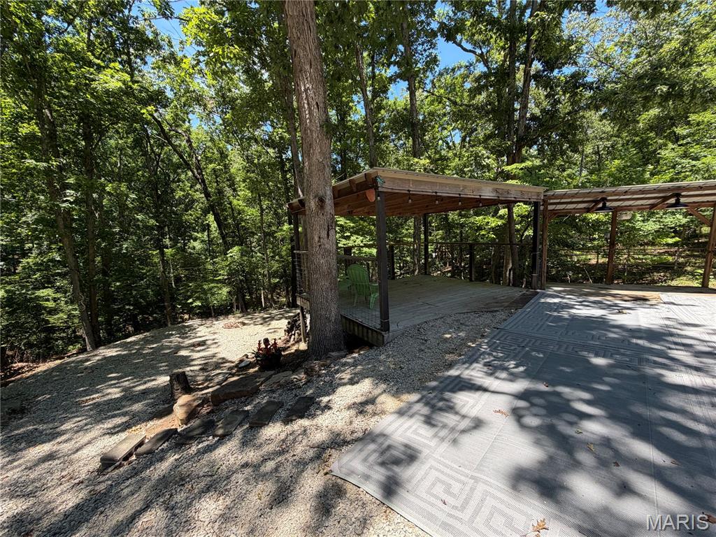 This spacious lake lot is located in the beautiful gated community of Lake Perry offering 1.25 acres of private oasis as well as a 2 covered decks for entertainment. This property has existing connection to electric, water and the SEWER SYSTEM/ HOLDING TANK ALREADY INSTALLED. This worry-free lot provides ample space to park your campers/boats/SXS's or to build offering plenty of room for a nice new home. With 2 RV/camper hookups already in place, invite your friends and family and enjoy immediately! Lake lots are flying off the market, don't miss your chance! 1992 Suncatcher pontoon boat is included with the sale of the lot. The 2021 Montana 5th wheel is available for purchase.