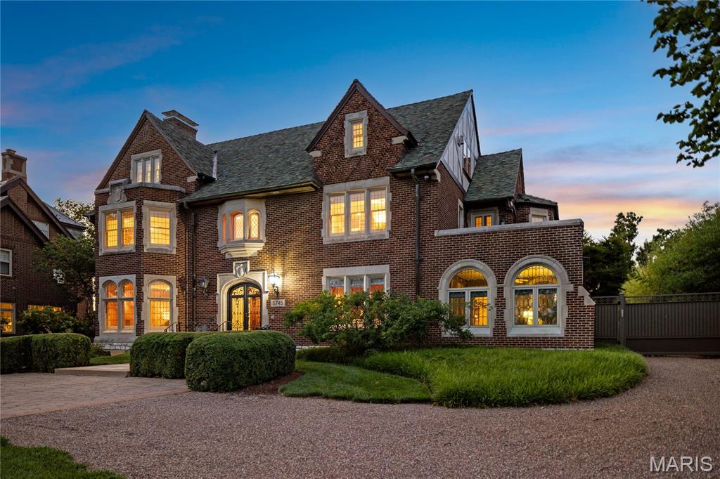 Resplendent. One of the most significant and unique homes along the storied Lindell Boulevard. 5745 Lindell sits on over 1.2 Acres in a premiere location across from Probstein golf course, adjacent to the History Museum and a straight shot to Art Hill and the Grand basin of Forest Park. At first glance; a traditional and historic home. What reveals itself behind the gated drive is an architectural masterpiece artfully recreated, expanded and totally reimagined leaving no detail untouched or expense spared. Owners have invested over $7.5 Million dollars in the property. Highlights include a living space exceeding 8,000 square feet, blending construction design appointments and styles seamlessly such as booming vaulted ceilings, which enhance natural light and space, open living areas, abundant windows and skylights, and incredible wood beams. Each structure on the property is joined by a covered and lighted walkway. The Pool is enclosed for year round enjoyment, with doors that open to expansive patios in summer, a full kitchen, fireplace, bathroom and steam shower. The Main house has expected staples of formal living and dining rooms with den and solarium. A 2 story addition creates a modern open-concept kitchen  and hearth room and breakfast area, overlooking meticulously manicured grounds and a vine enveloped trellised terrace. Perfect for large scale entertaining and fundraisers, the chefs kitchen includes a La Cornue range and exhaust hood, integrated SubZero refrigerators and freezers, and abundant counter and cabinet space. The Second Level hosts bedrooms, with several configuration and flex-space options. The vaulted third floor plays host to one of the most exceptional home libraries imaginable which can easily include a 5th bedroom if a different end use is desired. The deep pour and fully excavated Lower Level does not disappointment with it's many wow factors, finished with a Media Room, full kitchen, laundry room, spacious storage rooms, both finished and unfinished. The upgraded systems throughout the home are among the most impressive of any historic site of its kind, with full geothermal heating and cooling, Lutron lighting systems and programmable scenes. The 4-car Carriage House incorporates a full apartment above for guests for either long-term or short-term stays including a kitchen with Viking range, and oven. One-Of-A-Kind. Singular, worldwide.