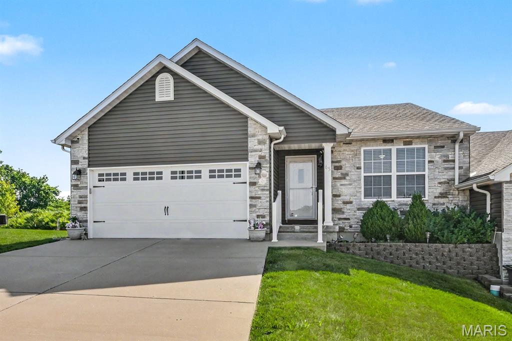 Welcome home to this beautiful villa, where eye-catching curb appeal and a gorgeous exterior create a stunning first impression! Step inside to discover thoughtful upgrades and modern finishes throughout. Great room with vaulted ceiling and gorgeous flooring that flows into the bright and stylish kitchen, designed to impress with quality stainless steel appliances, breakfast bar and stylish fixtures.  The spacious primary suite features new carpet and a beautiful bathroom complete dual sinks and walk in closet. Spacious secondary bedroom with new carpet and full bath complete the main level. Downstairs, the walkout lower level offers endless possibilities. With rough-in plumbing already in place, it's ready for your vision—whether you dream of creating additional living space, a recreation room, home office, hobby area, or another flexible-use space to fit your lifestyle. Combining quality upgrades, modern finishes, beautiful indoor and outdoor spaces, this move-in ready villa is an incredible opportunity you won't want to miss!