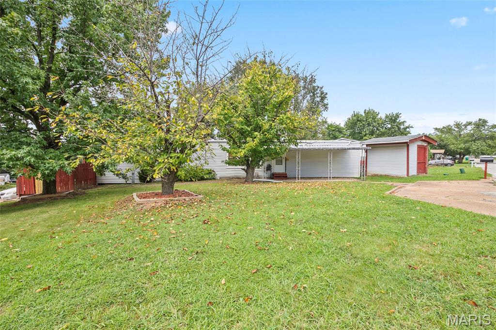 If you have been looking for an affordable place to call your own without sacrificing convenience or storage space, this 2 bedroom, 1 bathroom home is the budget friendly opportunity you have been waiting for. Tucked away on a corner lot, this property offers a rare and massive financial advantage: you own the land as well as the home, meaning there is absolutely no monthly pad rent to pay.

Inside, you will find a solid, completely livable space that is ready for your personal touch. Because you own the ground beneath you, it is the perfect setup for someone who wants to build immediate equity with a little TLC, or a budget conscious buyer looking to keep their monthly expenses permanently low while personalizing their space over time.

The outdoor setup is a huge bonus for hobbyists, collectors, or anyone with extra gear. The property includes a covered carport to protect your vehicle, plus three separate storage sheds that stay with the home. Whether you need a spot for lawn equipment, a dedicated tool zone, or extra space for outdoor gear, you will have all the room you need right on your privately owned lot.

The major highlight here is the unbeatable location. Positioned just a 1 minute drive from the bustling Gravois Bluffs area, you have shopping, dining, grocery stores, and entertainment practically at your doorstep. No long commutes for errands, as everything is right around the corner.

Stop paying sky high rent and invest in a place where you actually own the ground beneath your feet. Schedule a tour today and see the potential for yourself.