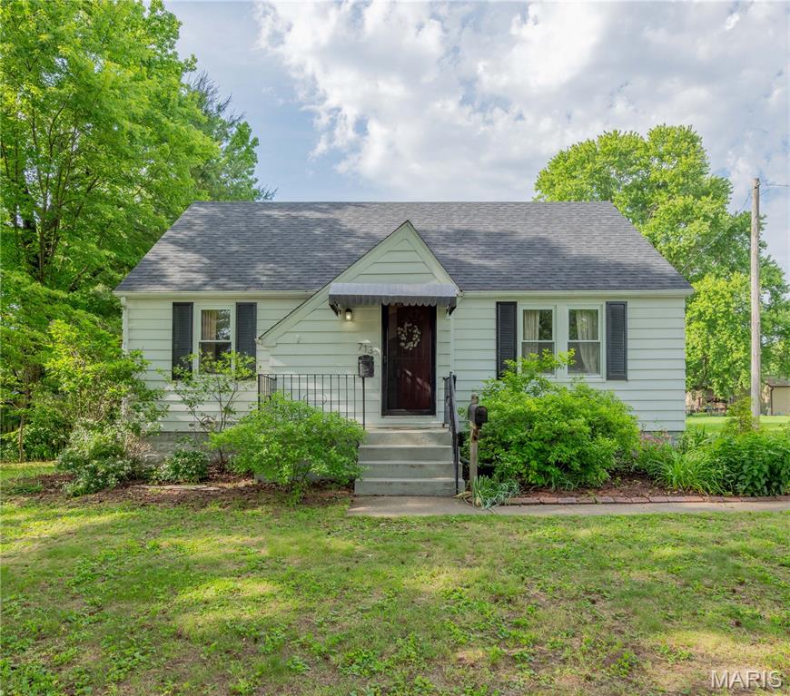 Charming updated home in a convenient Edwardsville location. The light-filled living room features built-in bookshelves and cabinets with large windows. Arched doorways add to the charm and the updated eat-in kitchen includes a dishwasher, gas range, newer refrigerator, and butcher block countertops. Stunning marble and tile bathroom with convenient laundry chute. Large bedrooms on the main floor and a spacious upstairs bedroom includes a large closet. Enjoy the huge beautifully landscaped backyard from the updated deck with an additional parcel (14-1-15-02-20-401-005) behind the fenced back yard.  The parcel with the home and garage is 90X150 lot and the second parcel is .45 acre.  Roof - Nov. 2023; New Deck Flooring 2026; Newer HVAC; Refrigerator -2022; Dishwasher - 2022.