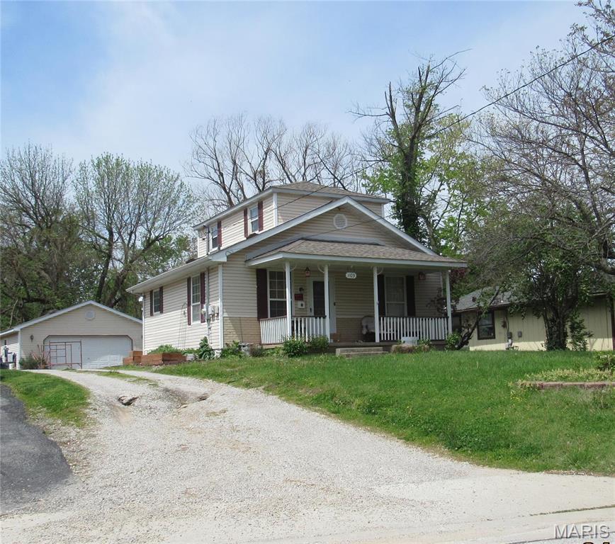 Vinyl sided 3 bedroom, 2 bath home, 1 bedroom on main floor, other 2 up, has a covered front porch and  a 2 car detached garage.  Property being sold in its "as is" condition.