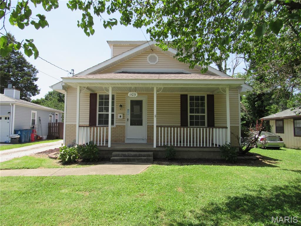 Vinyl sided 3 bedroom, 2 bath home, 1 bedroom on main floor, other 2 up, has a covered front porch and  a 2 car detached garage.  Property being sold in its "as is" condition.