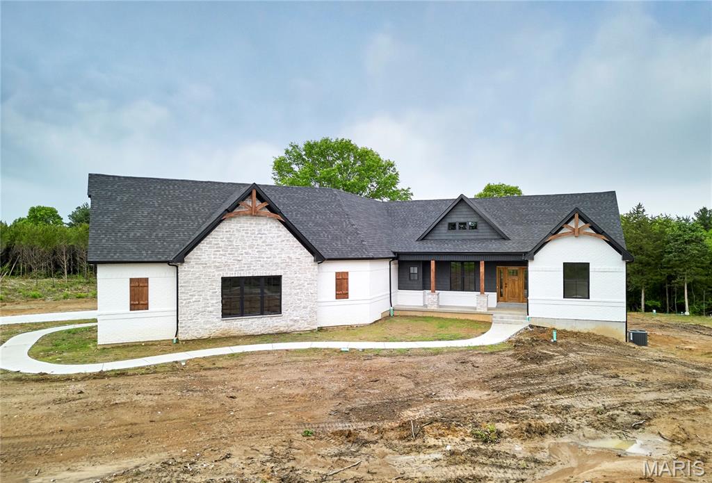 Luxurious living in a country setting all on a 5 acre unincorporated lot! This stunning custom built home includes full brick & stone elevation, side entry 3 car garage, 5 bed, 3.5 bath, open floor plan concept home, partially walk out finished LL, floating wood floors, black frame windows & vaulted ceiling throughout the dining, great room, kitchen & breakfast room. Enjoy entertaining in the spacious dining room & relaxing in the bright great room w/ floor to ceiling windows, custom stone electric fireplace & open staircase. Custom kitchen features pendant lighting, granite counter tops, dark custom cabinetry, custom range hood, dual wall ovens, SS appliances & bright breakfast room overlooking your covered deck area and private backyard. Master suite features coffered ceiling, huge walk in closet, custom over sized tiled shower w/dual heads, soaking tub, dual sink vanities & recessed lighting. The walk out LL offers 1,384 finished sqft with a stunning full brick & stone custom wet bar w/pendant lighting, granite counters, floating wood flooring & carpet. Bedroom and full bath complete the LL. Enjoy nature and serenity at its fullest with this beautiful property. NO HOA to deal with on this unincorporated stunner and adjoining 4.5 acre lot can but purchased for more land and privacy. See MLS # 26029175 SELLER TO OFFER $10,000 CREDIT TOWARDS RATE BUY DOWN OR BUYERS CONCESSIONS!