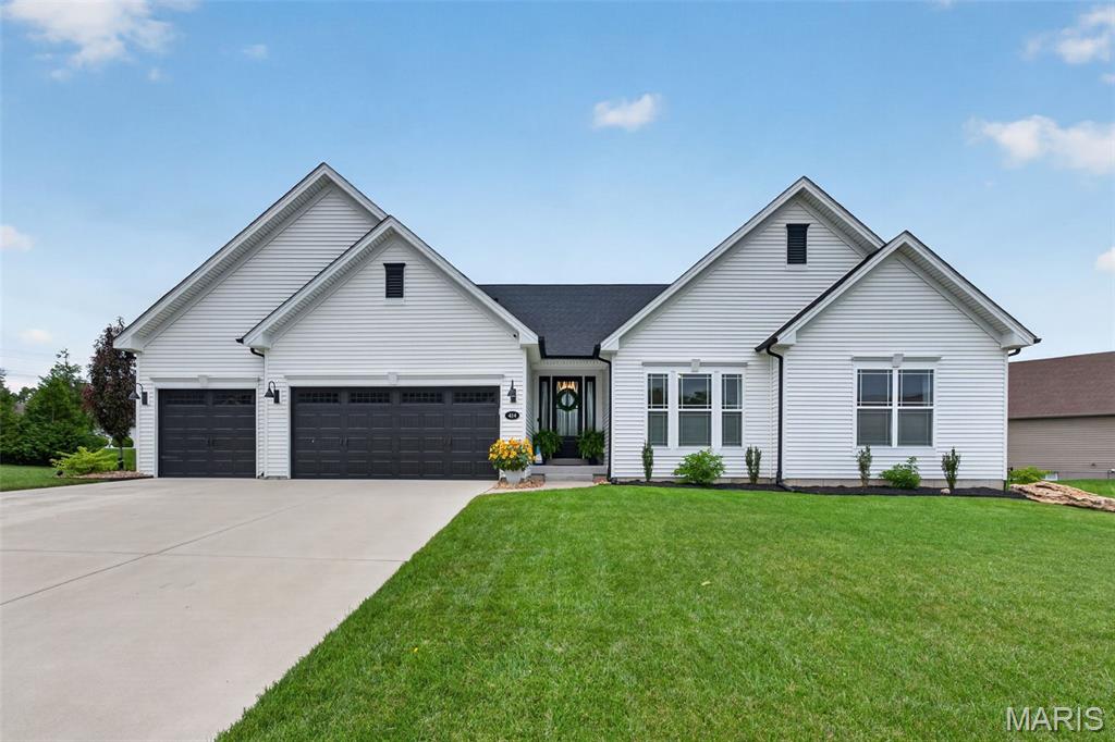 Prepare to be impressed by this exceptional Fischer & Frichtel ranch home in the highly sought-after Wyndgate Subdivision! Offering 4 bedrooms, 3.5 bathrooms, a 3-car garage, and beautifully designed indoor and outdoor living spaces, this home delivers the perfect blend of luxury, comfort, and functionality. From the moment you arrive, the impressively maintained lawn and landscaping create ideal curb appeal and a memorable first impression. Step through the front door to discover an open-concept floor plan filled with natural light, soaring ceilings, designer finishes, and seamless sightlines throughout the main living areas. The spacious family room is anchored by a stunning fireplace and showcases beautiful flooring, oversized windows, and an inviting atmosphere ideal for both everyday living and entertaining. The kitchen is truly the heart of the home, featuring custom cabinetry, quartz countertops, a large center island, gas cooktop, double wall ovens, stainless steel appliances, and a remarkable walk-in pantry. Just off the kitchen, the thoughtfully designed mudroom and laundry area offer built-in cabinetry and a drop-zone that keeps daily life organized and efficient. The primary suite is tucked away and provides a peaceful retreat with dual vanities, a step-in shower, and a spacious walk-in closet. Two additional bedrooms and a full bathroom complete the main level. The partially finished lower level expands your living space with a large living room, an additional bedroom with egress window, full bathroom, and a versatile bonus room that is currently being used as a home office. There is plenty of unfinished storage space that also offers endless possibilities for future expansion. Step outside and experience your own backyard oasis. The covered patio with retractable sunshades and a wood-burning fireplace creates the ultimate setting for relaxing evenings or entertaining guests all year round. Surrounded by picturesque landscaping that provides both beauty and privacy, this outdoor space feels like a true retreat. With incredible entertainment spaces, thoughtful upgrades throughout, desirable subdivision amenities, and an unbeatable location, this home has it all!