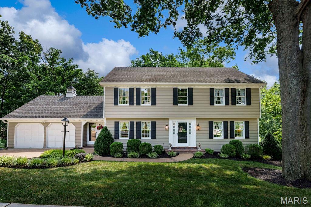 Nestled in the highly sought-after Dougherty Lake subdivision, this spacious 5-bedroom, 2.5-bath two-story home with 3149 SF of total living space offers breathtaking lake views and a serene, wooded setting that's hard to find. Enjoy peaceful mornings from the screened porch, deck, or the comfort of your family room & kitchen/breakfast area, all overlooking the picturesque subdivision lake. The beautifully landscaped backyard features a tranquil pond, charming bridge, and steps leading to the yard, creating a private outdoor retreat. Inside, the classic center hall floor plan offers a formal living room and dining room, perfect for entertaining. The inviting family room features a wood-burning fireplace with a brick surround, built-in bookcases, & sliding glass doors to the screened porch. The kitchen and breakfast room include peninsula seating, a built-in desk, and easy access to the deck and attached two-car garage. A convenient powder room completes the main level. Upstairs, the spacious primary suite includes a private bath & is joined by 4 additional bedrooms and a full hall bath, providing plenty of space for family, guests, or a home office. The finished lower level is designed for entertaining, featuring a large family/rec room with a 2nd woodburning fireplace, an antique bar & stained glass accent window, Tiffany-style ceiling light over the game table area, and sliding doors leading to a covered patio with more scenic lake views. Lakefront homes in Dougherty Lake are a rare find. Don't miss your opportunity to own this exceptional home where nature, tranquility, & everyday living come together in one of Des Peres' most desirable neighborhoods.