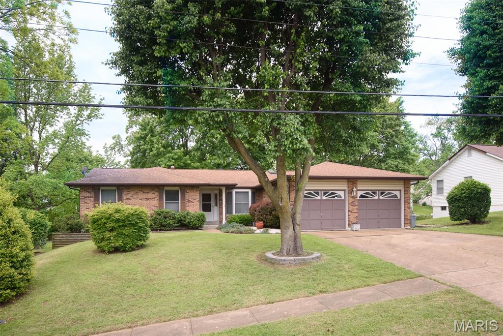 Hidden Gem in Bridgeton, MO! 3 bd 3 ba Ranch, open floor plan with vaulted ceilings, dual skylights, & plant shelf. Main floor laundry, 4 seasons sunroom off the eat in kitchen with bay window, that could easily double as a home office. Kitchen has newer granite countertops with lots of cabinet space and large peninsula island. Large primary suite with walk-in closet, en-suite bathroom has soaker tub, & separate shower. Woodburning fireplaces on main and lower levels, Large entertaining/recreation space in the walk-out basement with large bar, full bath, and extra sleeping room. Outside this almost half acre level lot boasts a 2nd driveway with a fenced in back yard and an additional 2 Story 28x40 RV garage for the car or travel enthusiast.
