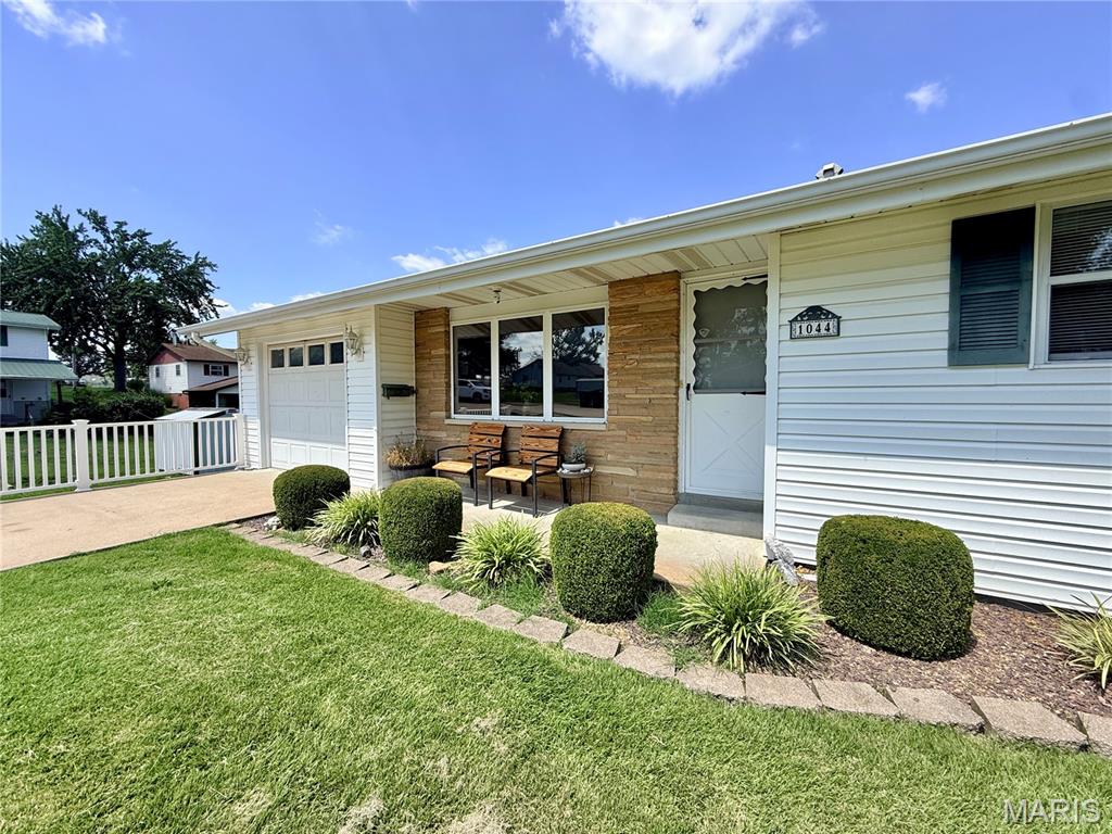 Welcome home to this move-in ready 4-bedroom, 1.5-bath home offering plenty of space inside and out! Freshly painted with new flooring throughout the main level, this home is ready for its new owners.  The main floor features three spacious bedrooms, a bright and airy living room, an eat-in kitchen, and a full bathroom with an Onyx walk-in shower. The finished lower level provides additional living space with a second kitchen area, a recreation room, a fourth bedroom, and a convenient half bath—this space is perfect for guests, entertaining, or multi-generational living.  Outside, you'll find a tuck-under John Deere garage, an oversized covered patio, a detached garage, & a greenhouse. The fenced backyard is surrounded by beautiful mature landscaping and lush foliage, creating a peaceful outdoor retreat. This property offers the perfect blend of comfort, functionality, and outdoor enjoyment.