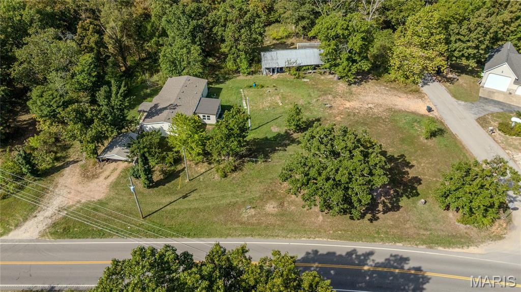 Discover the perfect blend of comfort, functionality, and peaceful country living in this spacious 3-bedroom, 2-bath home set on just over an acre of beautiful land. This inviting property offers the best of both worlds — a quiet retreat surrounded by nature, yet conveniently located just minutes from town for shopping, dining, and everyday amenities. Step inside and be welcomed by a bright and airy interior designed for easy living. The sunroom provides a cheerful space to enjoy your morning coffee or unwind with a good book, filling the home with natural light throughout the day. The updated kitchen features plenty of cabinetry, modern appliances, and a generous pantry that ensures you’ll never run out of storage space. Large closets are thoughtfully placed throughout the home to keep everything organized. The layout offers a seamless flow between the living, dining, and kitchen areas, making it perfect for entertaining or relaxing with family. Each bedroom is well-sized, and every room includes ceiling fans to help maintain a comfortable temperature year-round. Outside, the property continues to impress with multiple storage buildings and carports providing flexible options for vehicles, equipment, or hobbies. A spacious 20x10 shed sits in the back, ideal for use as a workshop, garden shed, or additional storage space. The expansive yard offers plenty of room for gardening, outdoor gatherings, or simply enjoying the tranquility of country life. Mature trees provide shade and privacy, creating a peaceful setting you’ll love coming home to. With low utility costs and the space to spread out, this home offers incredible value and endless potential. Whether you’re starting out, downsizing, or looking for a quiet place to settle, this property checks all the boxes. Schedule your private showing today and experience all this wonderful home has to offer!