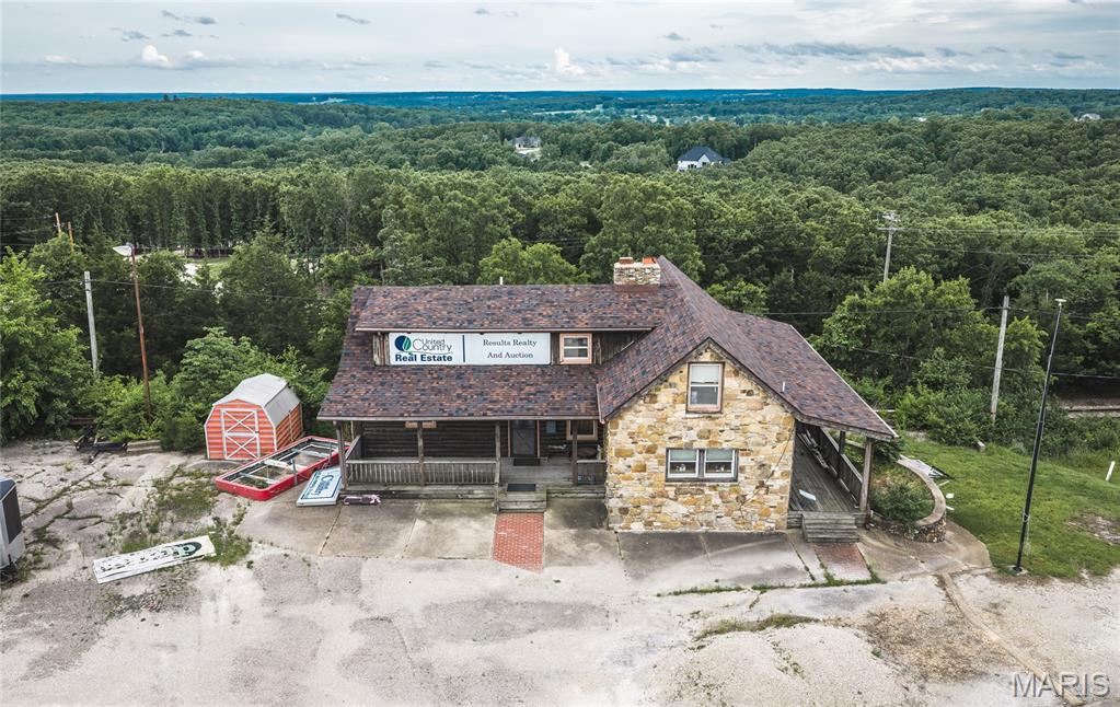 Exceptional commercial opportunity with prime visibility and easy access directly off I-44 Interstate! This unique property features two versatile buildings, making it an ideal setup for a variety of business opportunities, live/work potential, retail space, office use, or investment purposes.
The office building offers a warm, inviting lodge-style atmosphere with exposed wood and beams throughout, creating a rustic, outdoor-cabin feel that truly stands out. The office building includes 3 bedrooms, 2 bathrooms, a loft area, and a basement with a garage door for additional storage. A brand-new roof has recently been installed, adding even more value and peace of mind.
The second building currently operates as a rock retail shop and features an open main-level floor plan, perfect for retail, showroom, or other commercial uses. Upstairs includes two additional rooms and a bathroom, offering flexibility for office space and further business operations. The current tenant is interested in renewing the lease.
With outstanding interstate exposure, high visibility, and convenient access, these properties are perfectly positioned for businesses looking to maximize traffic and accessibility. Endless potential awaits with this one!