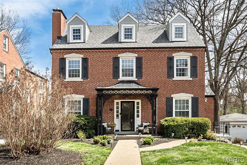 PRICE IMPROVED! Luxury living awaits in this move-in ready condo in the Clayton School District. This updated 2-bedroom, 2-bath Richmond Heights property is centrally located near restaurants, shops and access to major travel corridors. With its charming wrought iron pergola,  the unit's private entrance leads to the second floor unit. It's here that the surprises start--a jaw-dropping chef's kitchen will delight, with soaring 2-story vaulted ceilings, multiple newer windows, maple custom cabinetry, stainless appliances, granite counters, and a welcoming breakfast area flooded with natural light. Lovely hardwood floors, period millwork and high ceiling lines provide character not often seen in comparable condos. The living room features built-in bookshelves, chair rail and coved crown molding, fireplace and more. A graceful arch separates the spacious dining room, with ample space for parties and family gatherings. The primary suite is a true retreat, with newer carpets, a huge walk-in closet with custom organizer & a spacious, updated ensuite bath with glass shower, soaking tub, custom cabinets, and double sinks. Additional highlights include a convenient in-unit LG steam feature stackable washer & dryer, a second bedroom and updated full bath, basement storage locker and a 2-car tandem garage. Outside, enjoy the tranquility of the immense backyard. The list of amenities is long, with newer roof and gutters and Clayton and Brentwood shops, dining & parks just minutes away. This condo offers a move-in, sophisticated lifestyle in an ideal location!
