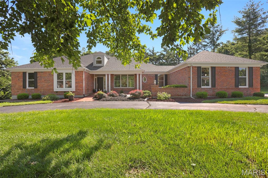 Welcome to this rare and beautifully designed ranch home, perfectly situated on 1.3 private acres in the desirable Country Place subdivision. A soaring entry foyer welcomes you, flanked by an elegant formal dining room and a private study with French doors-ideal for a home office or quiet retreat. The spacious family room features a stunning vaulted ceiling, a floor-to-ceiling tiled gas fireplace, and large windows that frame peaceful views of the backyard. The expansive kitchen is the heart of the home, offering abundant work space, a generous breakfast area and a wall of windows that fills the space with natural light. Step directly onto the screened porch, continue to the deck and enjoy the privacy and beauty of the back yard. The main level includes a luxurious primary suite along with two additional bedrooms that share a spacious hall bath. The finished walkout lower level feels anything but a basement, thanks to the wall of windows and two sets of French doors that bring in exceptional natural light. This level offers two additional oversized bedrooms with walk-in closets, including one with an extra 6 foot closet, a full bath, a large U-shaped bar, a cozy fireplace and an expansive recreation area perfect for entertaining family and friends. Completing this home is a spacious three-car garage.