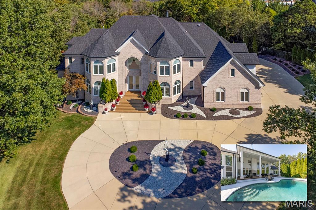 Stunning 1.5 Story home sitting on a spectacular 1.44-acre, cul-de-sac lot, in the prestigious Topping Pointe Estates subdivision - Award Winning Parkway West Senior High & Mason Ridge Elementary! This 5 bedroom, 5 full bath & 2 half bath showplace boasts over 7500 sqft of living space. From the moment you walk through the custom, leaded glass front doors, you will know you are home. The main floor is an extremely functional, open floor plan, designed for today's living and entertaining, featuring a separate formal dining room & living room, both with custom molding, bay windows & arched openings. A breathtaking great room with a wall of 2-Story picture windows with sunburst tops, bringing the outside in, and showcasing the incredible backyard area, gorgeous crystal chandeliers, and gas fireplace. A gourmet chef's dream eat-in kitchen with an abundance of custom cabinetry, Silestone Quartz countertops, a separate center island & a 2-tiered breakfast bar, top of the line appliances, including Dacor 6-burner gas cooktop, double ovens, Sub Zero commercial fridge & freezer, a custom organized walk-in pantry, and huge Butler's pantry, all opening to a wonderful breakfast room, a terrific study / home office with custom built-ins, and a dramatic hearth room, with 2 walls of 2-story picture windows, one with a gas fireplace in the center. If that is not enough, that main floor primary retreat is fabulous, with deep coffered ceiling, gas fireplace, bay window, with sitting area, custom organized walk-in closet, a spa-like bath, with extra-large jetted tub, right next to a gas fireplace, separate walk-in shower with custom onyx tile, dual custom vanities, one with a built-in desk. You will also find a huge main floor laundry room, with custom cabinetry, sink, 2 powder rooms, and a 2nd full bath off the patio / pool, with a stackable laundry unit, completing the main floor. Walk up the beautiful handcrafted, grand double staircase, with iron balusters, or the rear stairs off the kitchen to the 2nd floor, and you will find 4 spacious bedrooms, 1 ensuite with its own full bath, a 2nd ensuite, but opening to the hall, a 3rd full bath, and an amazing bonus room, that could be a legal 6th bedroom. Additional features include newer roof & gutters (2025), zoned HVAC (Geothermal), Beam Central Vac system, security & irrigation systems, extensive landscaping & outdoor lighting, and an oversized 4-car side-entry attached garage, just to name a few. The walk-out lower level is 4300 sqft, currently unfinished, and has a separate staircase directly to the garage. It is just waiting for the new owner's imagination to kick in. Relax outside in your private oasis, on the expansive, epoxied patio, with soaring 2-story ceilings, and brick wood burning fireplace, or take a dip in your fabulous free form, in-ground pool. The location could not better - near major hospitals, shopping, restaurants, county parks and easy access to major highways.
