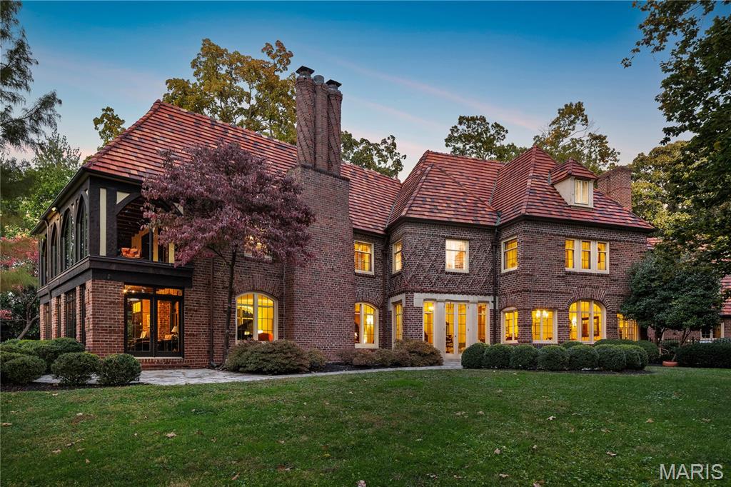 A compelling new price on this Resplendent Clayton property makes 8 Carrswold the strongest value in executive properties. Shown with a fresh face and modern perspective. Resting high above the lane on 1.4 acres in Clayton's most coveted, exclusive neighborhood.  Created for maximum privacy the driveway winds to the far side of the property where the front door receives guests and garage access is conveniently located. Now reimagined for the current age, a rendering illustrates a majestic and inspirational facade with an entirely new approach and front entry. A classic Martiz and Young designed home with signature details of  a grand entry and sweeping staircase, terrazzo floors, open spacious rooms, oversize fireplace and 7,700 SF of living space. The architect's concept of bringing the outdoors inside, floods the home with natural light with numerous sets of French doors and floor to ceiling windows. Terraces, patios and intricate architectural details represent craftmanship of a bygone era. The floor plan is open and flows easily. Spacious Living Room, den and formal Dining Room create romantic and elegant settings for finest entertaining and parties. Kitchen has been opened to include an eat-in breakfast room. Existing sunroom is shown as a new Reception area;  concepts of other rooms are transformed with minimal effort and expense. An expansive en-suite primary bedroom on second level includes a Glen Alspaugh glass walled hang out room overlooking the grounds. A private elevator accesses main and 2nd levels (Currently disconnected.)  4+ additional bedrooms on second and third floors. Secluded pool is an oasis for outdoor sophisticated living. Ample space for addition of more garage parking, if desired. A short walk to  casual and formal dining options and all downtown Clayton has to offer. Limitless potential and opportunity!