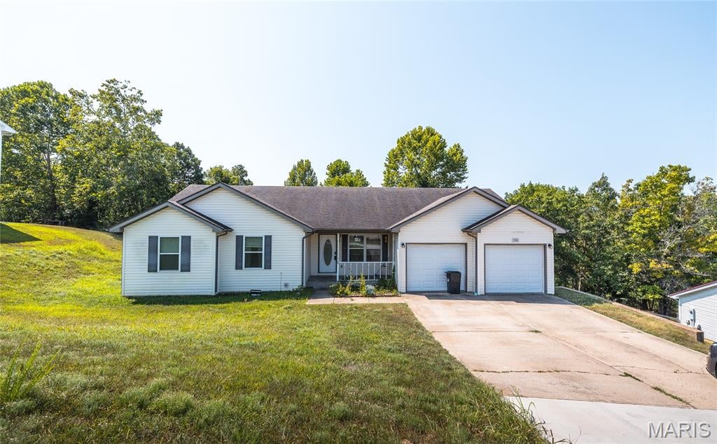 Welcome to this beautifully maintained 4-bedroom, 3-bath home located in one of St. Robert's most desirable subdivisions, offering the perfect combination of space, style, and convenience. Just minutes from the main gate of Fort Leonard Wood and close to shopping, restaurants, and everyday amenities, this home is perfectly situated for an easy commute and comfortable lifestyle.

The inviting covered front porch sets the tone for the warmth you'll find inside. Luxury vinyl plank flooring flows throughout the main living areas, creating a modern look that's both durable and easy to maintain, while plush carpet adds comfort to each bedroom. The spacious kitchen is designed for everyday living and entertaining, featuring stainless steel appliances, ample cabinet space, and plenty of room to gather. As an added bonus, the washer and dryer are included, making your move even more convenient.

The fully finished walkout basement expands your living space with a huge family room that's perfect for movie nights, game days, or hosting guests. Step outside to enjoy the fully fenced backyard, complete with both a patio and a brand-new, fully replaced deck, providing the perfect setting for outdoor dining, relaxing, or entertaining friends and family.

Whether you're looking for extra room to grow or a move-in-ready home in an unbeatable location near Fort Leonard Wood, this property delivers everything you've been searching for. Don't miss your chance to own this exceptional St. Robert home—schedule your private showing today and experience all it has to offer!