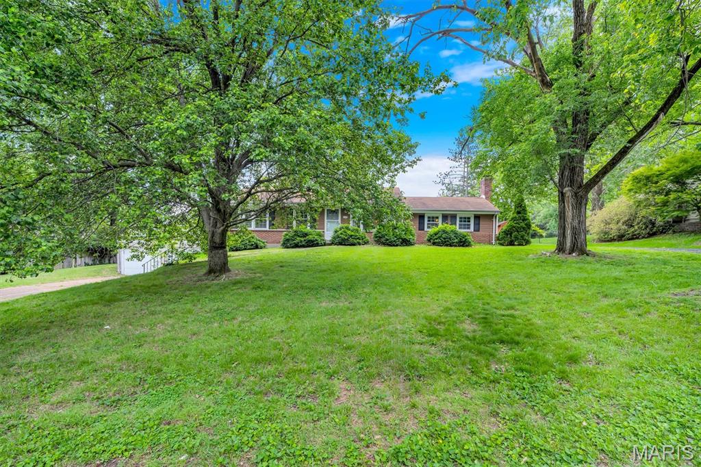 Back on Market: No Fault of the Seller and an AMAZING OPPORTUNITY for you! Discover a rare opportunity in Ballwin with this expansive ranch home offering over 1,900 sq ft above and additional 950 below, situated on a beautiful lot just shy of half an acre. Spacious, well-located, and full of potential, this property is ideal for an investor or a family ready to add sweat equity for HUGE results. Key Features Include: 3 bedrooms, 2 bathrooms, and a lower-level bonus room with a walk-out basement ready for your finishing touches for another curated + usable space. FOUR-car garage total: 2-car tandem attached garage plus detached 2-car garage designed for a workshop, hobby space, business or mancave. Off Street Parking is STELLAR with multi-drive parking areas on both sides of the home and perfect for entertaining. A circle drive could be easily added for additional curb appeal + convenience. Large primary ensuite with potential for a walk-out to the tandem garage rooftop!  Add this modern upgrade and spacious design element to your master and create an area for coffee in the mornings or late nights under the stars w/a hot tub option.  Multiple level interior living areas including family room+ living room for flexible layouts, entertaining, play area or work-from-home space. Option for an open-concept kitchen is easily obtainable in the large, bright and airy eat-in kitchen area. Laundry area is conveniently located on the main level as well. Park-like yard with mature trees, ideal for barbecues, parties, kids play areas, pets, and a possible pool addition with nice patio seating and fully fenced in. Utility shed is included for lawn equipment, bikes, and recreational gear. Neighborhood + Lifestyle: Centrally located in a Five-Star school district near shopping, dining, gyms + recreation. Enjoy walking trails, the river. the farmers market, concerts, fireworks and much more at Blue Bird Park, Vlasis Park, and Castlewood State Park. The Pointe Recreation Center. North Pointe Aquatic Center + Ballwin Golf Course are minutes from home with resident perks for the whole family. 
Condition + Opportunity: The property is being sold AS-IS; sellers make no disclosures as they have not occupied the residence. This is a standout opportunity to add value through cosmetic updates, reconfiguration, or larger renovations of YOUR choice to create a dream home! This rare combination of space, location, lot size + FOUR car garage capacity makes the home attractive to any Buyer seeking a true gem with high residual value in the heart of downtown Ballwin. Thank you for your interest, and I look forward to your visiting the property!