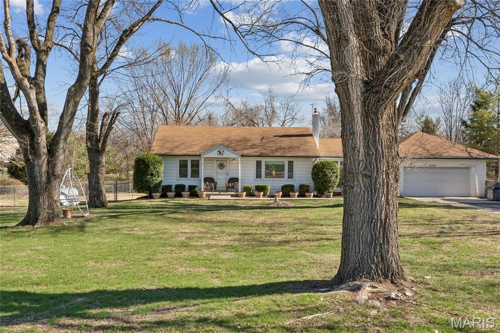Charming and hard-to-find property in St. Louis County situated on 2 beautiful acres! This inviting 2-bedroom, 1 full bath home offers the perfect blend of comfort and space, featuring beautiful hardwood floors and a cozy fireplace in the living room that adds warmth and character. Well-maintained and move in ready! Additional family room to host friends and family. The property boasts a large front yard and a gorgeous backyard filled with mature trees and plenty of open grass, creating the ideal setting for relaxing, entertaining, or simply enjoying the outdoors. Brand new roof is getting installed very soon. Located in the Hazelwood West School District and just minutes from shopping, dining, and everyday conveniences, this home is perfect for anyone looking to enjoy a little bit of land without leaving the St. Louis area. Opportunities like this in St. Louis County don’t come around often!