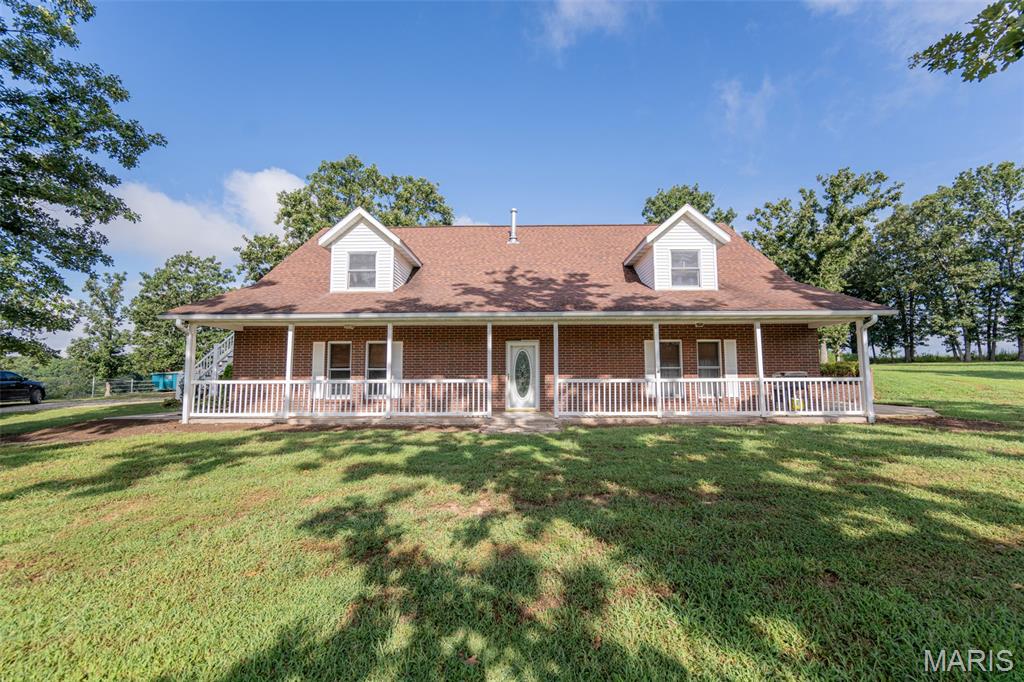 Discover the perfect blend of comfort, privacy, and outdoor living on this beautiful 35 acres m/l property! This all-brick earth contact home offers 4 bedrooms, 2 bathrooms, and a spacious layout designed for both everyday living and entertaining.

The main level features master bedroom, roomy kitchen with custom oak cabinetry, and a spacious living room highlighted by a vaulted ceiling and loft overlooking the living area. The loft adds flexible space for an office, reading area, playroom, or additional gathering space. The home also includes a convenient 2-car attached garage.

Step outside and enjoy the peaceful setting from the maintenance-free deck and side patio—perfect for morning coffee, small family gatherings, or relaxing evenings while taking in the surrounding beauty.

For those who love the outdoors, this property truly shines with **two stocked lakes**! A beautiful approximately 3-acre lake with an island sits behind the home, while a second approximately .75-acre lake is located in front. Both lakes are stocked and ready for fishing, offering endless opportunities for recreation and relaxation right at home.

A 36x24 workshop/2-car garage provides additional parking, storage, or workspace for hobbies and equipment. With expansive acreage, two stocked lakes, multiple garage spaces, and a spacious home, this property offers a rare opportunity to enjoy country living with plenty of room to spread out. Come see all this exceptional property has to offer!