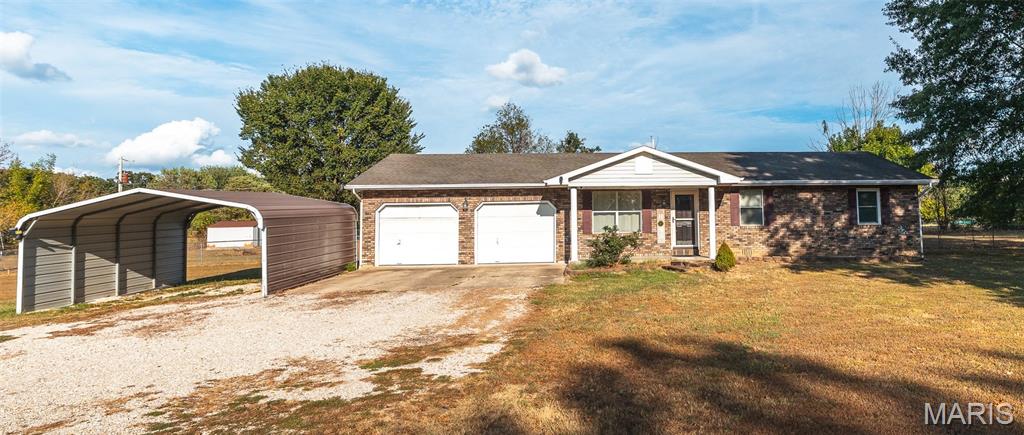 Welcome home to this inviting 3-bedroom, 2-bath ranch-style home situated on nearly a full acre, offering the space and flexibility to enjoy both comfortable indoor living and an incredible backyard. With a level lot, practical features, and plenty of room to make your own, this property is ready for its next chapter. Step inside to a functional single-level layout designed for easy everyday living. The kitchen features a newer smart range, approximately two years old, with built-in air-fry capabilities and convenient smartphone connectivity. Preheat the oven remotely and have it ready to go when you walk through the door—perfect for busy evenings or effortless meal prep. One of the highlights of this property is the huge, level backyard. Fully enclosed with chain-link fencing, there’s plenty of room for pets, play, gardening, outdoor entertaining, or simply enjoying the extra space that comes with nearly an acre. Step out to the sunroom/back patio area and create your favorite spot for morning coffee, weekend gatherings, or relaxing while overlooking the backyard. A carport provides convenient covered parking for 2 vehicles, while the metal storage shed offers additional space for lawn equipment, tools, outdoor gear, or seasonal storage. If you’ve been searching for a ranch-style home with a large fenced yard, convenient one-level living, and room to enjoy the outdoors, this property deserves a closer look. Schedule your private showing today and come see all the possibilities this home has to offer!