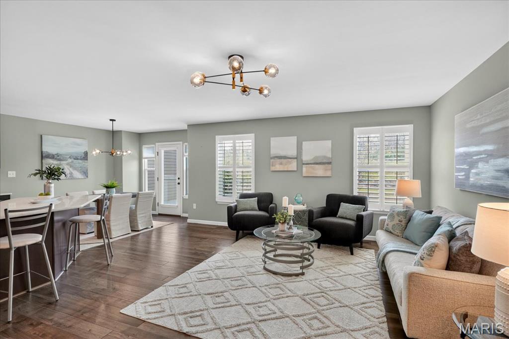 Welcome to this beautifully updated 2BR/4BA Villa nestled in a quiet, desirable neighborhood with easy access to Highway 270, shopping, and grocery stores—offering both convenience and comfort in one exceptional package.  The exterior boasts low-maintenance vinyl siding with an attractive brick front, covered soffits, and a welcoming covered front porch. Enjoy peaceful views from the private back patio overlooking a serene pond, along with the convenience of a spacious two-car garage.  Step inside to a bright, open floor plan featuring wood flooring, updated hardware, and classic six-panel doors throughout. The large Family Room is filled with natural light and enhanced by plantation shutters, modern lighting, and seamless flow into the kitchen and breakfast area—perfect for both everyday living and entertaining.  The Kitchen is a standout with wood flooring, quartz countertops, a stylish tile backsplash, and a peninsula island with seating. You'll also find stainless steel appliances, a smooth-top electric range with double oven, 42-inch cabinetry, and recessed (canned) lighting. Convenient access to both the garage and back patio makes daily living effortless.  Upstairs, the spacious Primary Suite offers newer carpeting, plantation shutters, a coffered ceiling with ceiling fan, and two large walk-in closets. The En Suite bath features a comfort height double sink vanity, linen closet, and an oversized walk-in shower. The second bedroom is generously sized with carpeting, shutters, a ceiling fan, and its own walk-in closet.  The finished lower level expands your living space with cozy carpeting, recessed lighting, plantation shutters, an egress window, and a convenient half bath. You'll also find an electric washer and dryer hookup and a brand-new water heater installed in 2026.  Thoughtfully updated and tastefully decorated, this villa offers modern finishes, functional space, and low-maintenance living—all in a fantastic location.