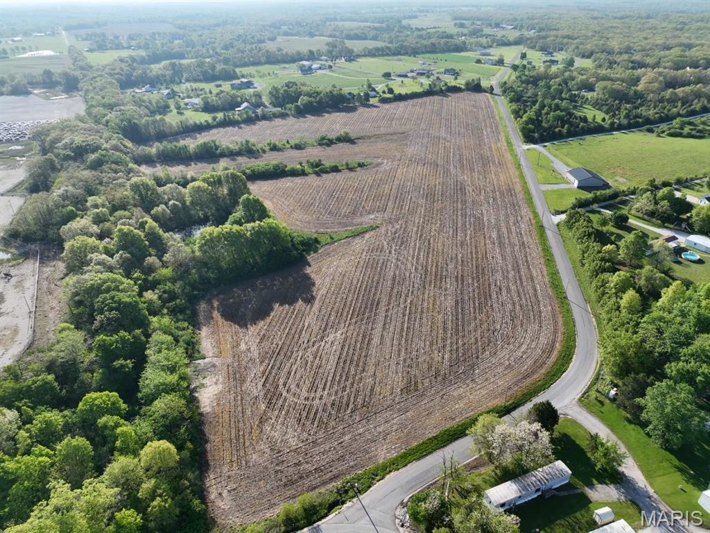 32.13+/- surveyed acres ideally located just 1 mile west of Troy on the south side of Hwy 47 in Missouri. This expansive tract offers approximately 2,000 feet of blacktop road frontage, providing excellent accessibility and visibility. The land features gentle, rolling topography, making it well-suited for a variety of uses including agricultural, recreational, or potential development. Utilities are conveniently available with electric and water along the road frontage, adding to the property's versatility and ease of improvement. The acreage is primarily open, offering wide, usable ground, while a scenic tree line along the northern boundary provides natural beauty, privacy, and potential habitat for wildlife. With its size, location, and layout, this property presents a rare opportunity and may offer the potential to divide into two parcels. Whether you're looking to expand a farming operation, invest in land, or explore future development possibilities, this property checks all the boxes.