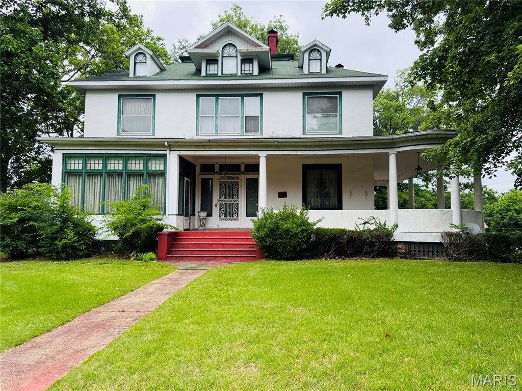 Step into a piece of Poplar Bluff history with this stunning 1892 Queen Anne style home offering over 4,000 sq. ft., 3 bedrooms, and 3.5 baths filled with timeless charm and unforgettable character. From the expansive wraparound porch to the intricate original details throughout, this home offers craftsmanship and history that simply cannot be recreated today. Inside you’ll find beautiful parquet floors, soaring 10- and 11-foot ceilings, original coal-burning fireplaces, pocket doors, stained glass, gingerbread fretwork, leather wallpaper, and oversized 10-foot doors. The formal dining room even features a serving window designed to open to the outdoors for entertaining and parties. Additional historic touches include a breakfast room, upstairs smoking parlor, steam radiant heat, and remarkable architectural details around every corner. During both World War I and World War II, bandages for the Red Cross were rolled in the basement, adding another meaningful chapter to this home’s incredible story. The stained glass above the front door was commissioned by the artist who restored the glass in the Poplar Bluff Methodist Church. Lovingly maintained and well cared for over the years, this home is more than a property; it’s an opportunity to own a true piece of history. If you’ve dreamed of owning a historic showplace with unmatched character, craftsmanship, and a story to tell, this is one you must experience in person!!
