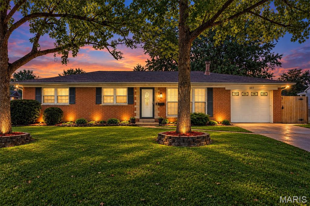 Wonderfully updated ranch in the heart of O'Fallon, conveniently located with its close proximity to schools, parks, and hospitals. The amount of livable square footage will surprise and delight you!  The home boasts beautiful hardwood floors with four bedrooms and three bathrooms. There are updates in every room, including fresh paint, and new lighting. The updated kitchen includes recessed lighting, butcher block countertops, newer backsplash, and stainless steel appliances. The main floor bathroom has been beautifully updated, with a new vanity, white tile and an extra deep tub. The primary suite serves as a relaxing retreat with a new generous walk-in closet with tons of space, and an ensuite with a large glass-enclosed shower. The generously sized family room is the perfect area to gather and enjoy movie night or relax in front of the fireplace. If exercising is your thing, an 8x14 room is waiting for you! Do you need more space? The finished lower level has a large family room, a bonus room that has a walk-in closet and full bathroom. The yard has several stately mature oak trees and a fruit tree. The backyard is fenced with a large concrete patio, and deck with decorative lighting.