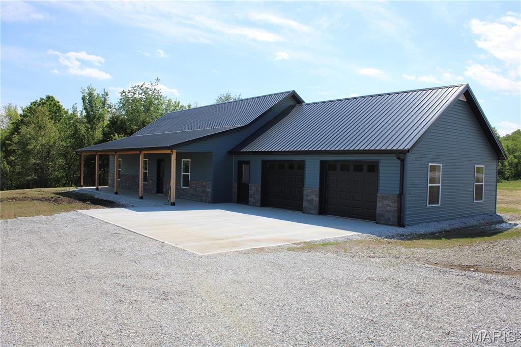 Three bed, two bath home with a two car attached garage sitting on 3.57 surveyed acres located just south west of Hannibal, MO. Open floor plan design. Kitchen with granite countertop and stainless steel appliances. Fridge and stove will be installed shortly. Master bedroom with a walk-in closet and master bathroom. Home is located on tract 6 on the survey picture.