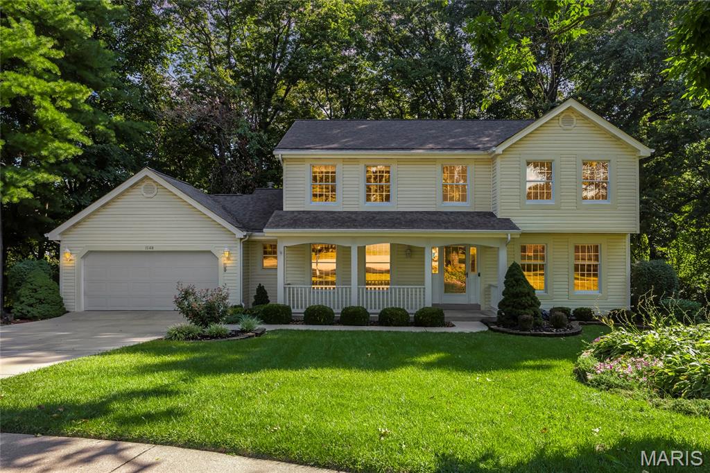 Welcome home to this charming, well maintained two-story residence tucked away on a quiet cul-de-sac! This immaculate home offers plenty of space for comfortable living, featuring a large kitchen with beautiful oak cabinetry and abundant storage. The inviting family room has built in bookcases with a fireplace that creates a warm gathering space with a blend of carpet and wood flooring throughout the main living areas.

Convenience abounds with an oversized main-floor laundry room and an extra-large drywalled garage offering ample room for vehicles, storage, or hobbies. Upstairs, the spacious primary suite features a luxurious updated bath with dual sinks, a soaking tub, separate shower, and a generous walk-in closet. Three additional bedrooms offer comfortable accommodations with plenty of space for family, guests, or a home office.

If you are wanting to add even more space to the home, the unfinished walkout basement, plumbed for an extra bath and including a work sink, provides even more opportunities!

Enjoy relaxing in the screened-in porch overlooking a tree-lined backdrop, providing privacy and a serene outdoor setting. Located on a desirable cul-de-sac lot, this lovely home combines space, functionality, and a beautiful natural setting—ready for its next owner to enjoy!