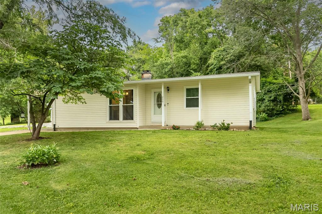 This adorable 3 bed 1.5 bath home is move in ready and looking for new owners. This ranch home has been updated and lovingly taken care of. The neighborhood is wonderful and very convenient to schools and highways and shopping. The elementary school is in the neighborhood, just a block away. Step inside you will find gleaming hardwood floors, spacious living room offering vaulted ceilings which opens up to the bright dining area with large window and lovely built-ins. The kitchen is a wonderful use of space. Plenty of counter space and 42-inch cabinets give you plenty of storage. Stainless steel appliances, granite counter tops, subway tile backsplash make this kitchen a focal point of the home. The primary bedroom is large, wood flooring, 2 windows to let the natural light shine in. The other 2 bedrooms have handsome hardwood floors and are nice sized. There is a full updated main floor bathroom and as a bonus you have a 1/2 bathroom too. This home has lovely finishes. Wait to you head down to the finished lower level. The space has unlimited possibilities.  There is a custom-made bar is a gift for you to host your birthday parties, football parties, and family gatherings. The home sit on a 1/2 acre so there is plenty of space for your outside activities. 
This home has so much to offer, come take a look.